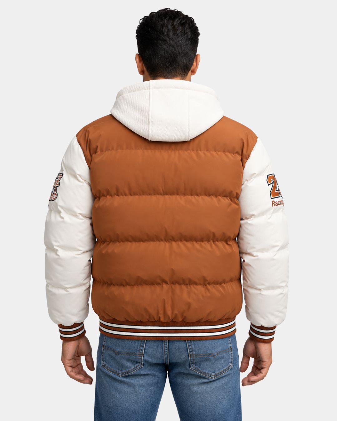 Back view of a brown and white hooded varsity puffer jacket with embroidered patches and striped ribbed trim.