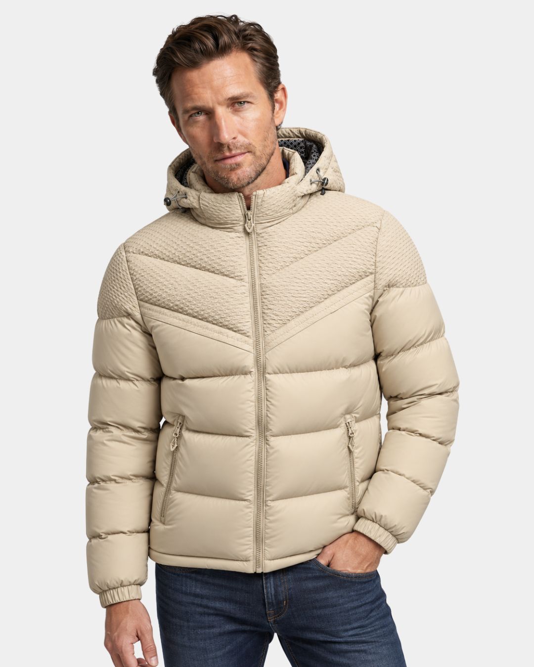 Beige men’s winter puffer jacket with an adjustable hood, full-zip front, and textured chevron upper panel detailing.