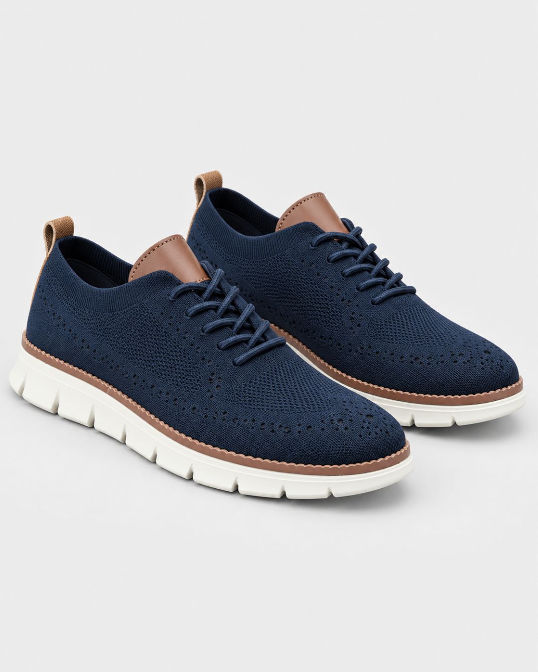 Navy blue mesh dress sneakers with brown leather accents, lace-up closure, and a cushioned white EVA sole.