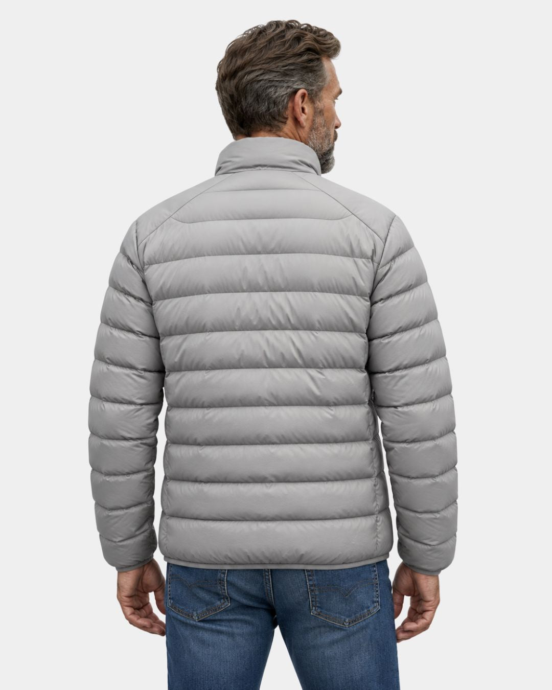 Back view of a man wearing a light grey, quilted duck down puffer jacket with a stand collar and zip-up design.