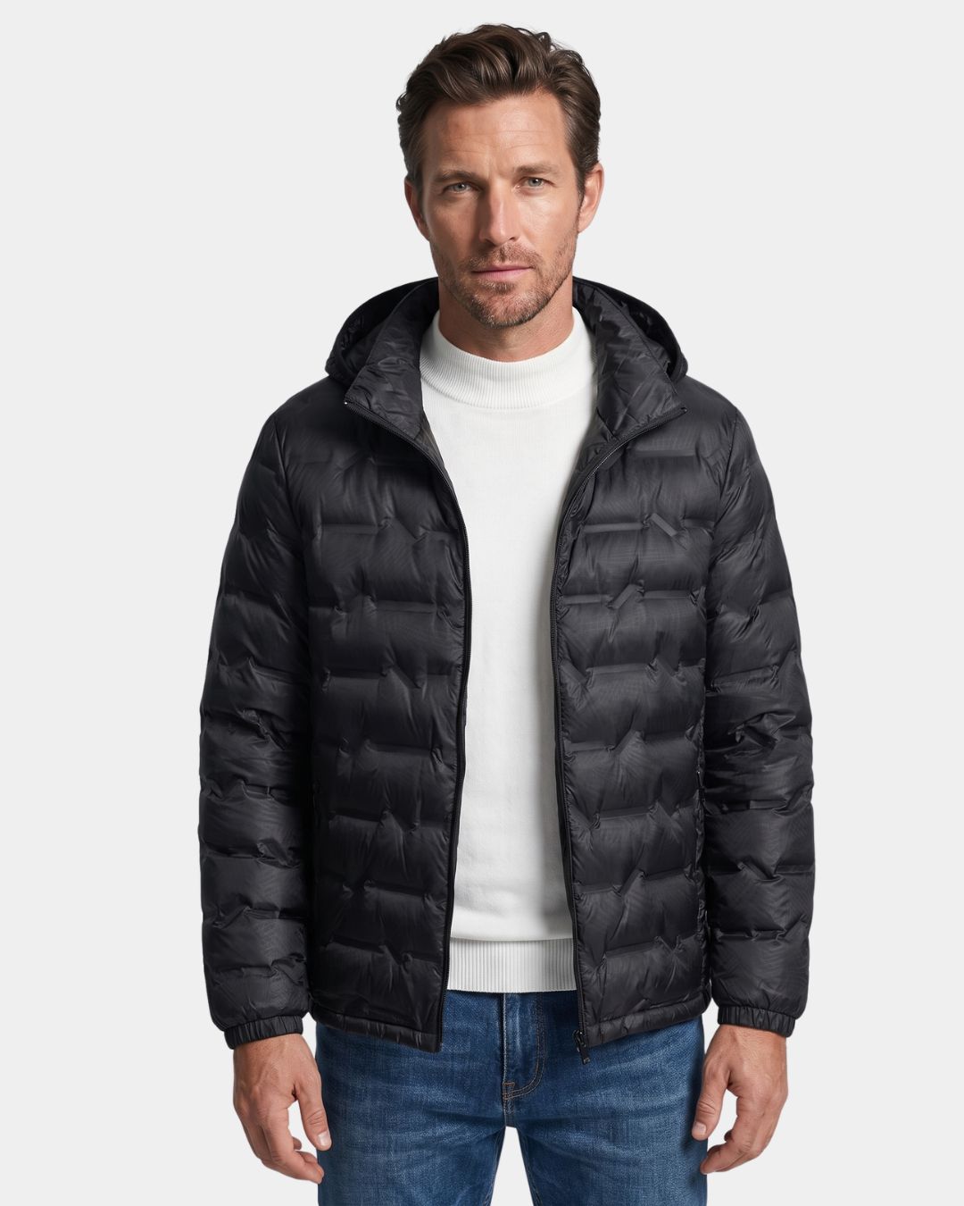Man wearing a black lightweight quilted down puffer jacket with a detachable hood and full-zip front.