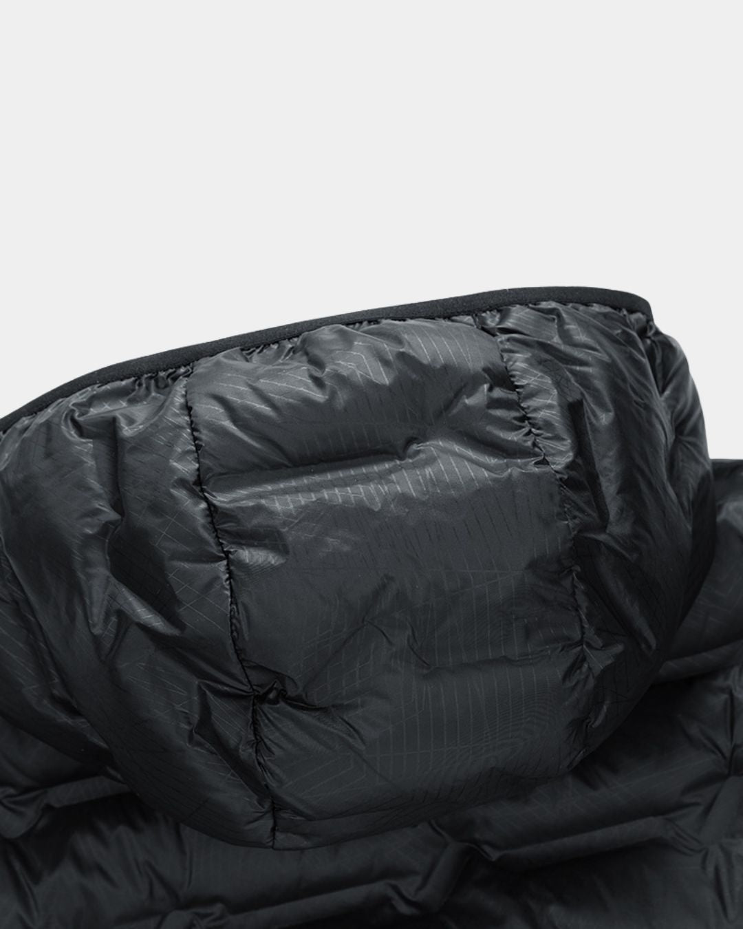 Black quilted down puffer jacket hood with a waterproof grid-patterned fabric and insulated duck down filling.