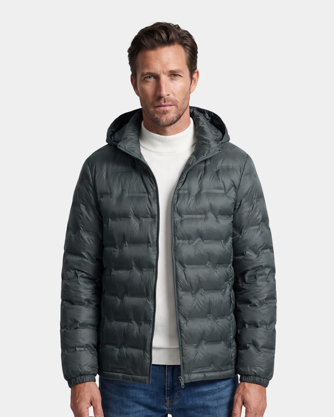 Man wearing a dark grey, lightweight quilted down puffer jacket with a detachable hood and full-zip front.