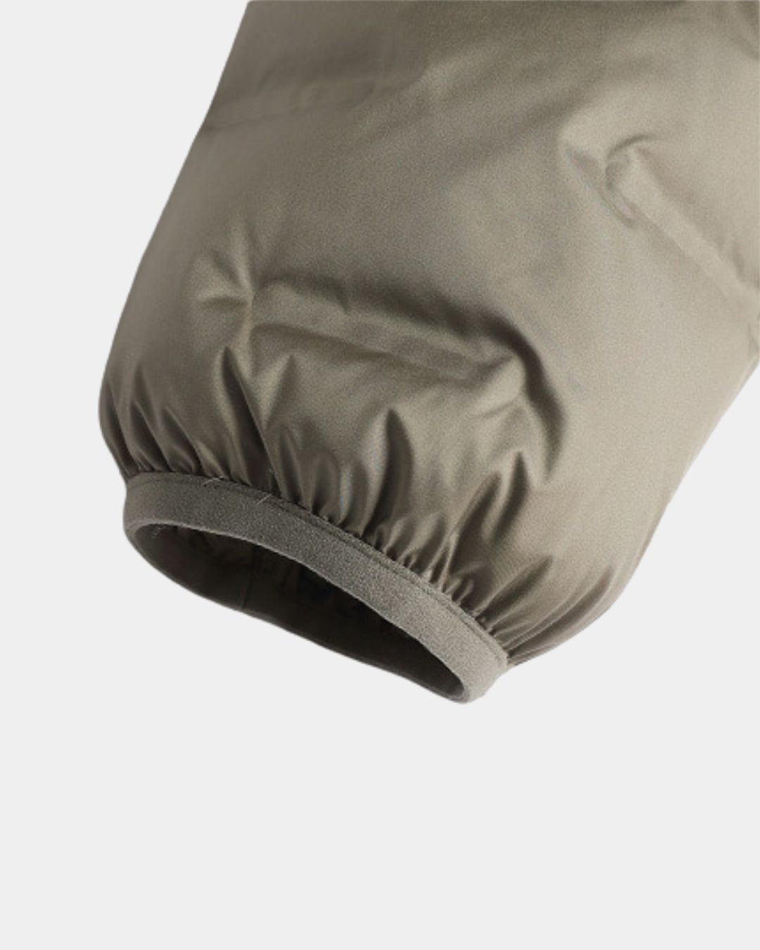 Olive green lightweight down puffer jacket sleeve with an elasticated, abrasion-resistant cuff.