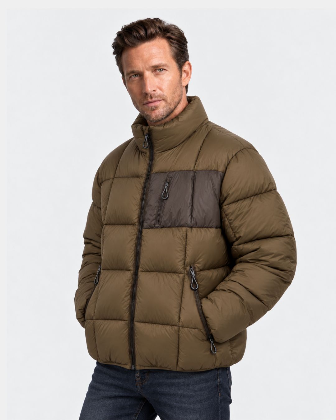 Man wearing an olive green padded puffer jacket with a dark chest pocket, stand collar, and full front zipper.