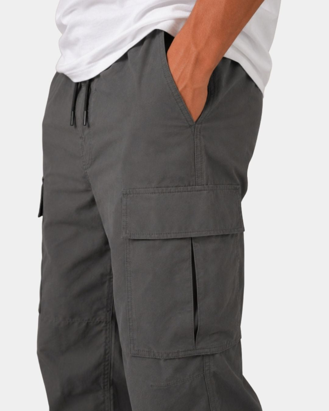 Charcoal grey relaxed-fit cargo pants with an elastic drawstring waistband and large side flap pockets.