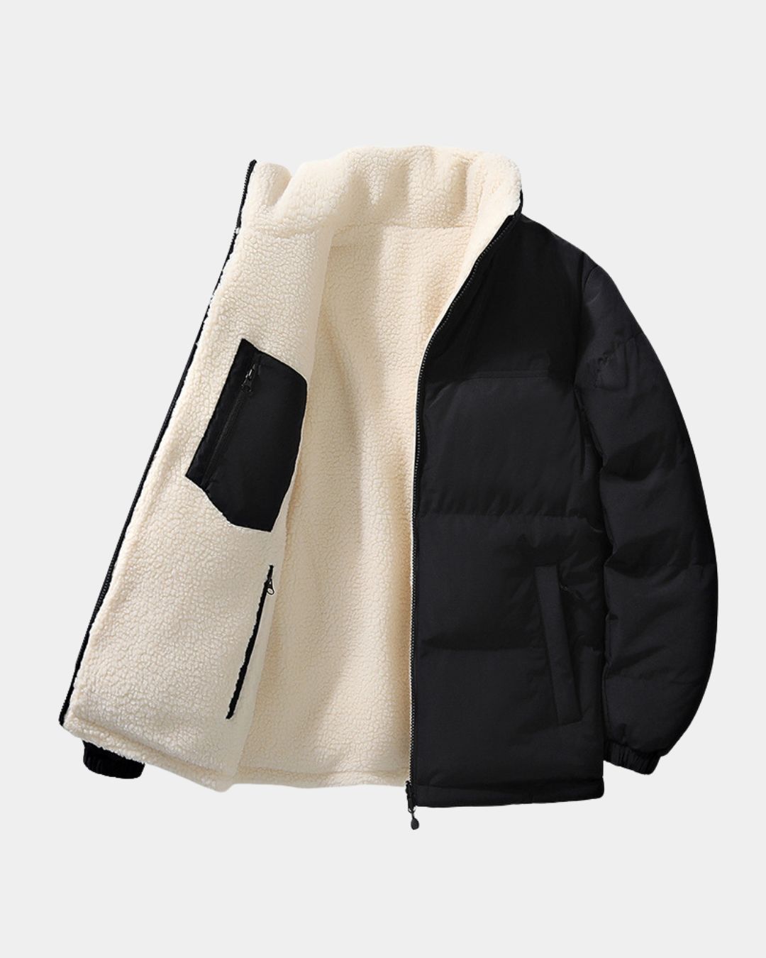 Men’s reversible black puffer jacket with a soft cream-colored fleece lining, stand collar, and full-zip front.