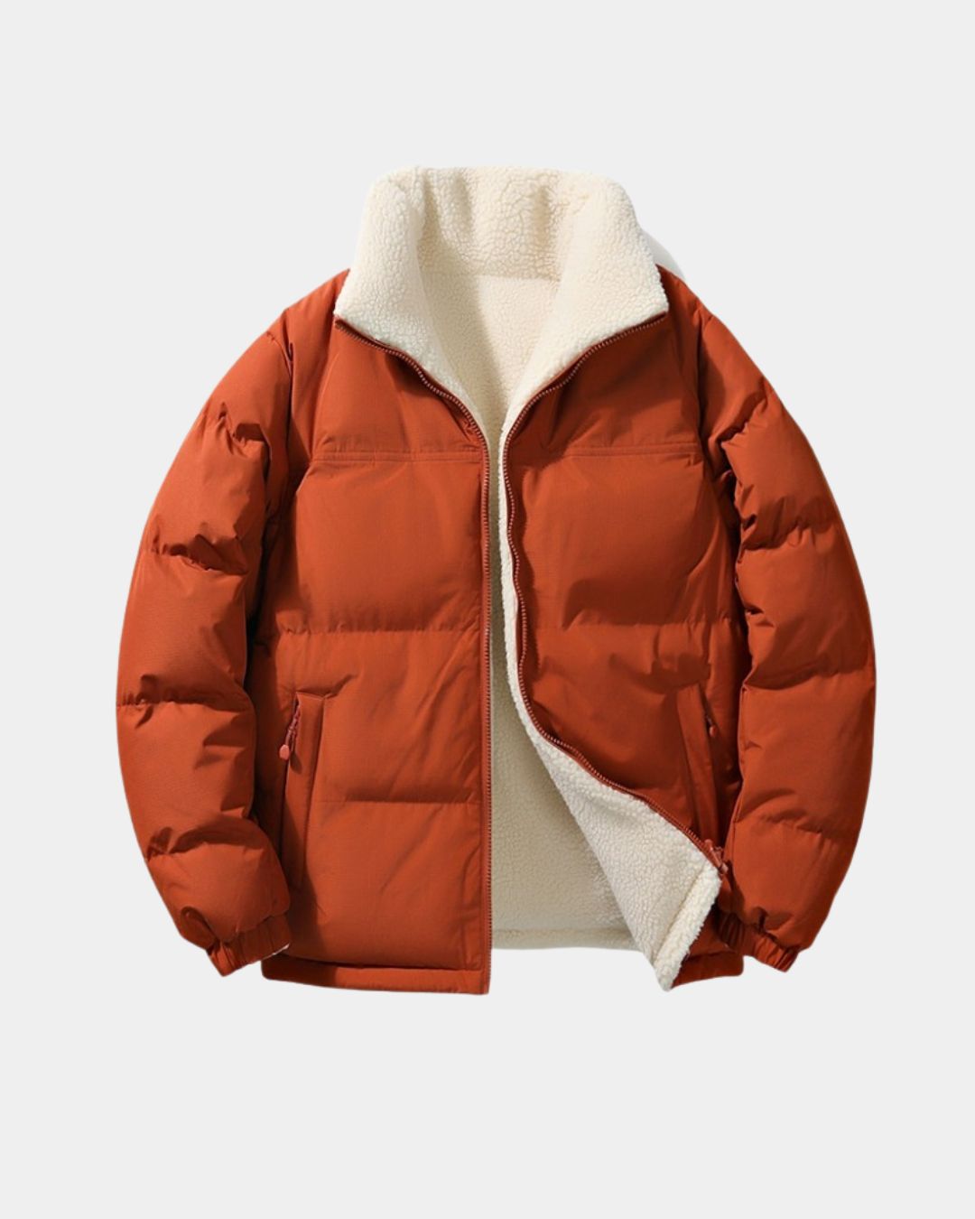 Men’s reversible rust orange puffer jacket with a cream-colored fleece lining, stand collar, and full-zip front.