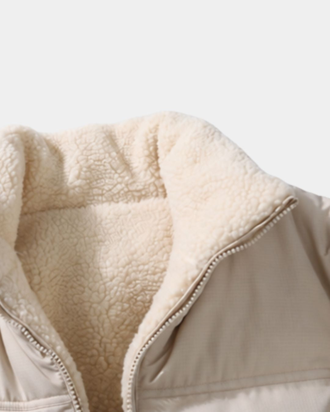Beige reversible puffer jacket with a soft cream fleece lining and a high stand collar with a full-zip front.