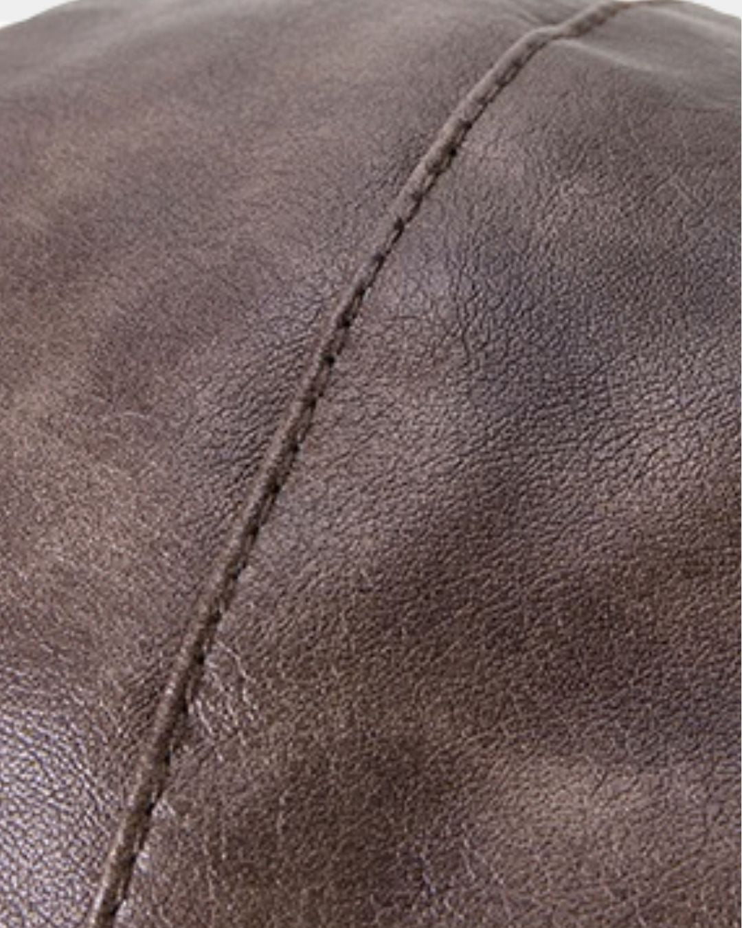 Close-up of a brown, waterproof, and windproof men’s trapper hat featuring detailed stitching on a smooth, durable outer surface.