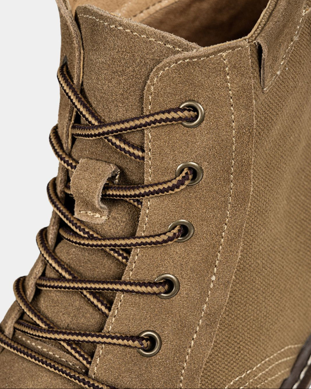 Tan suede and canvas lace-up ankle boots with metal eyelets and contrast stitching.