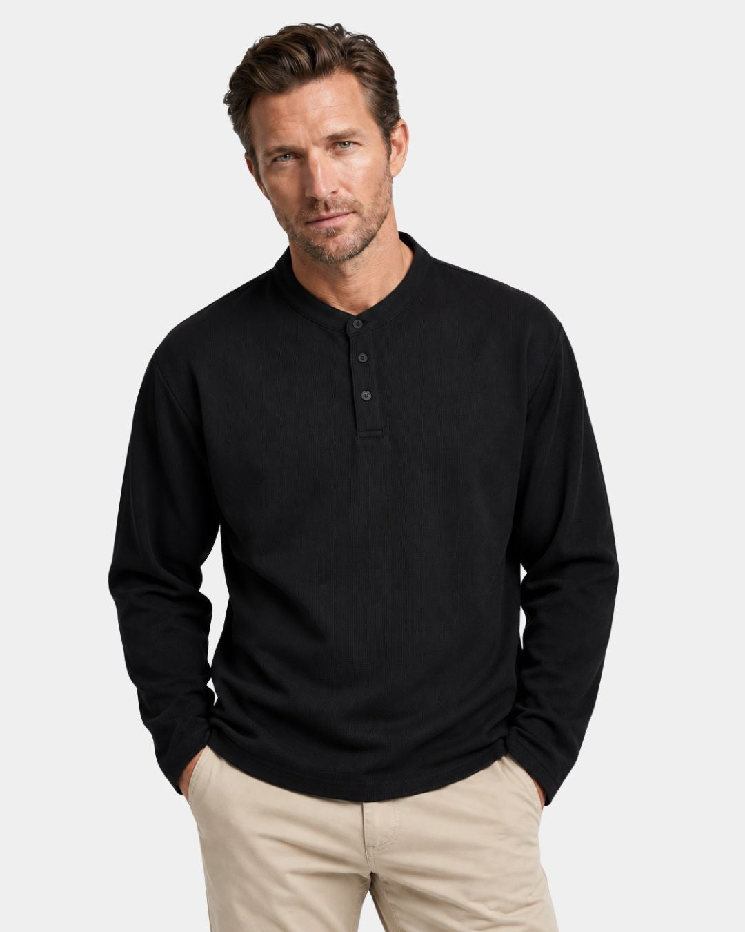 Men’s black long-sleeve henley shirt in a textured waffle knit with a three-button band collar and dropped shoulders.