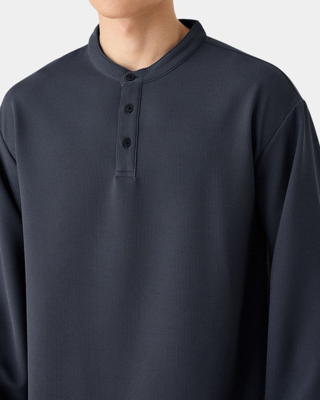 Charcoal grey long sleeve henley shirt with a textured waffle knit, band collar, and three-button placket.