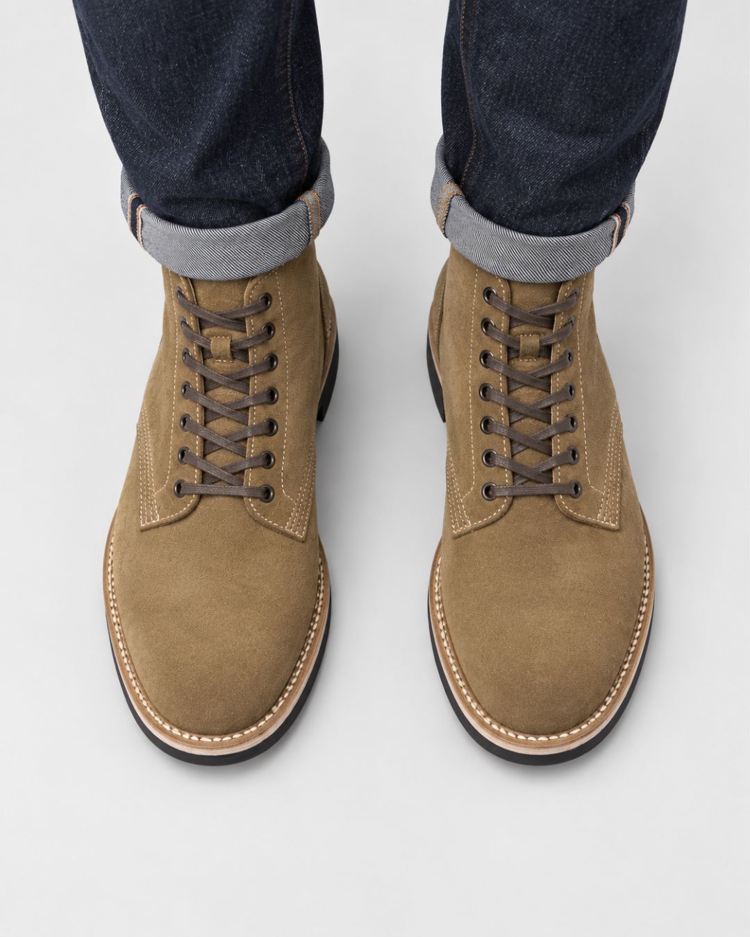 Men’s tan suede lace-up ankle boots with contrast stitching, round toes, and durable rubber outsoles.