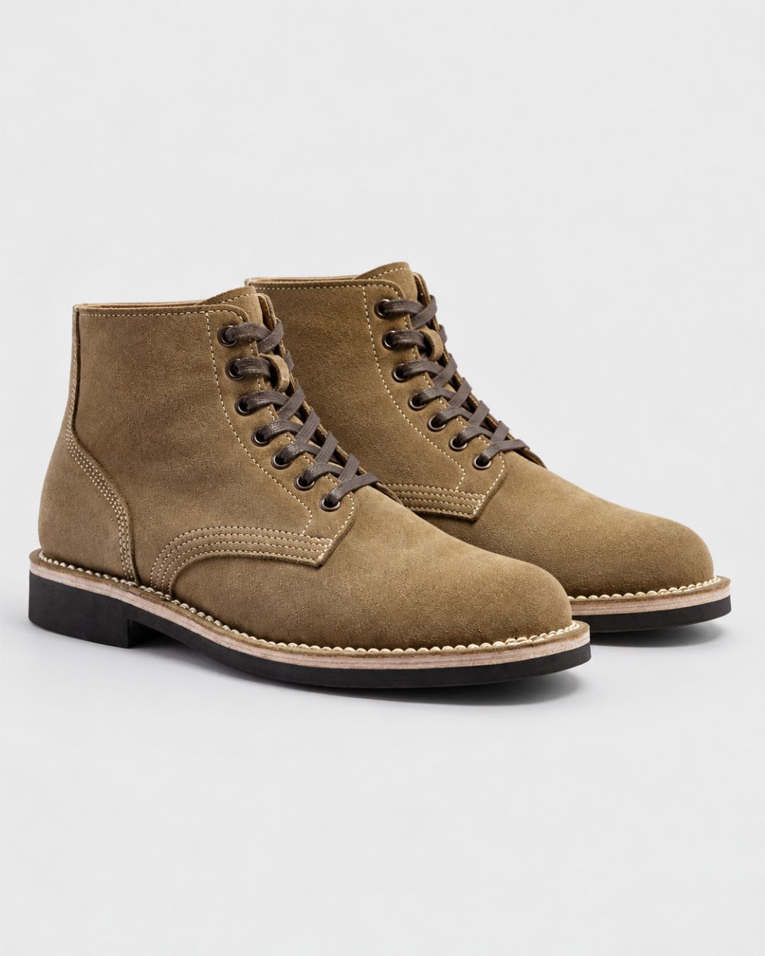 Men’s vintage-style tan suede ankle boots with contrast stitching, round toes, and durable black rubber outsoles.