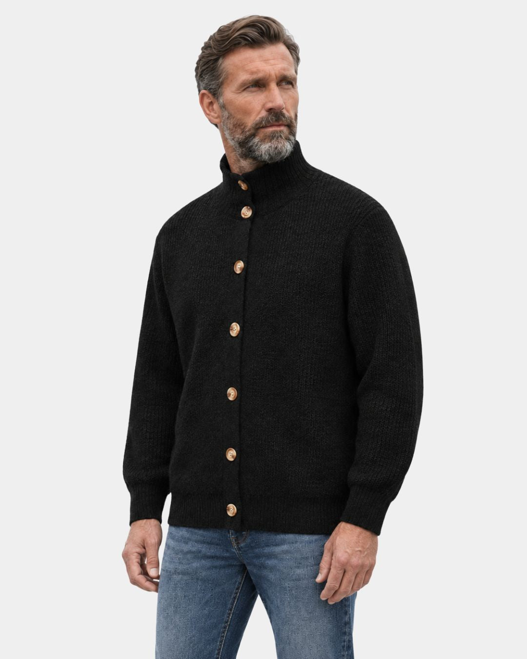 Men’s black high-collar knit cardigan with a button-up front, ribbed texture, and relaxed fit worn with blue jeans.
