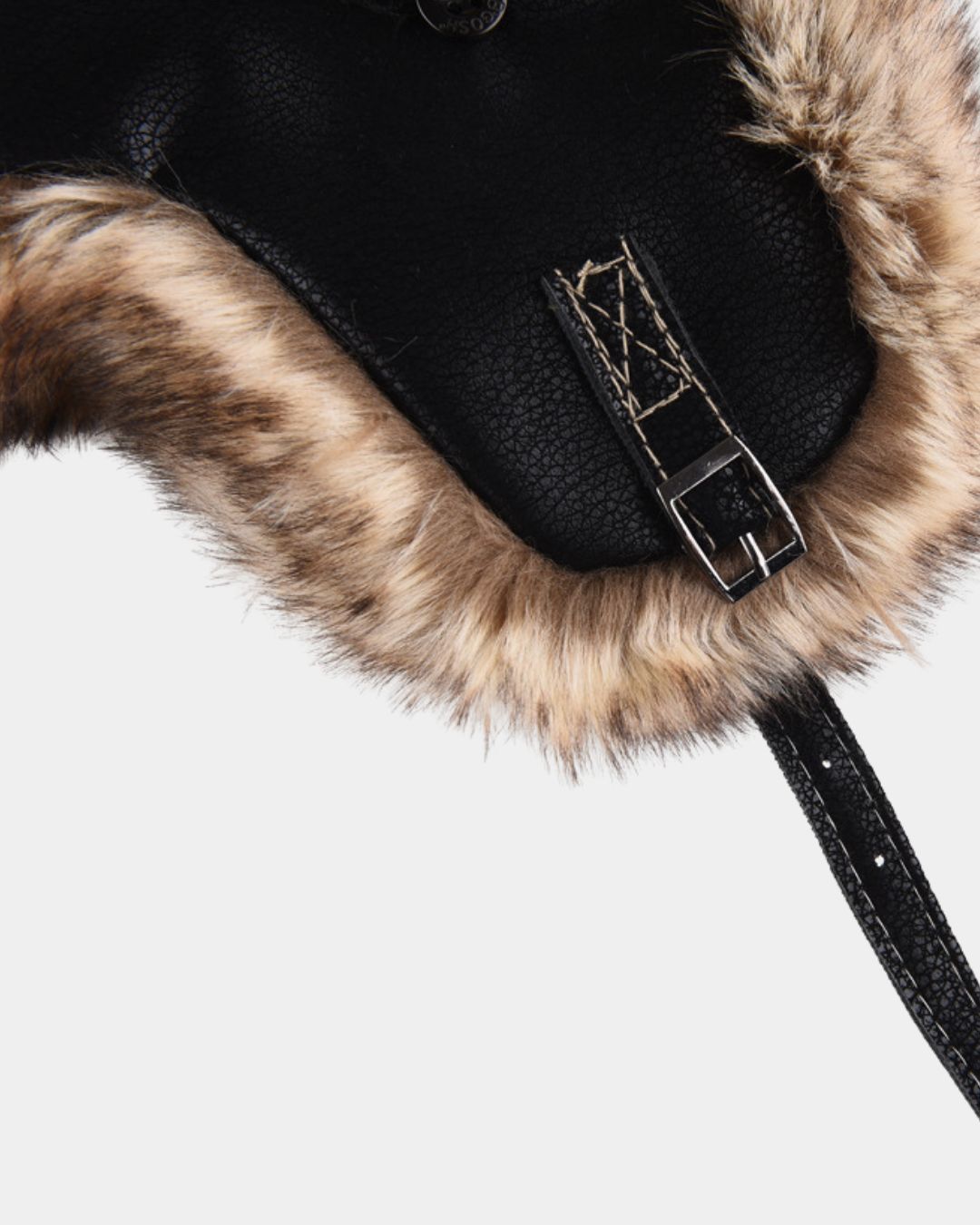 Black faux leather aviator trapper hat with plush brown faux fur trim, featuring a side buckle strap and rugged textured finish.