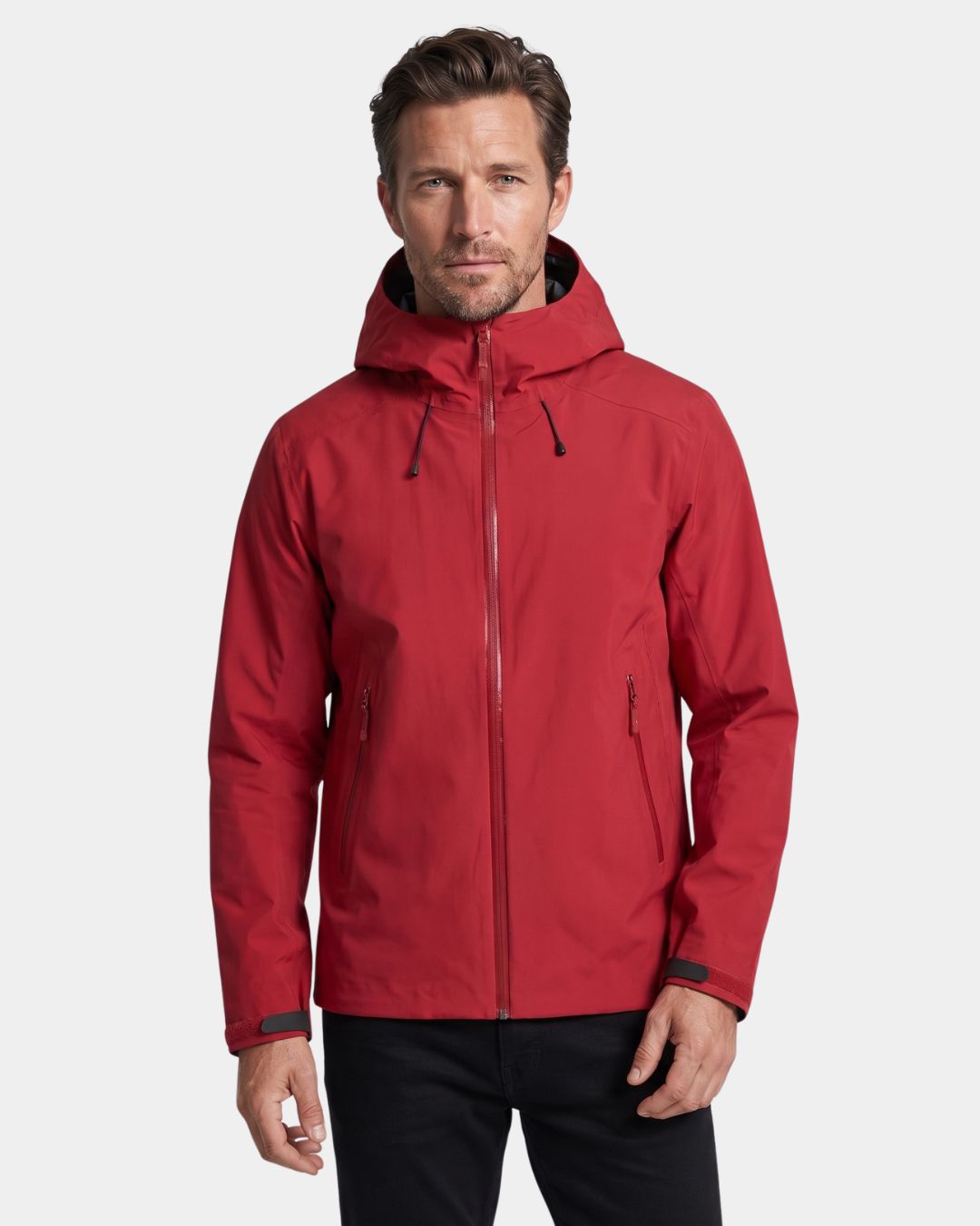 Man wearing a red waterproof hooded hiking windbreaker with a full-zip front and adjustable cuffs.