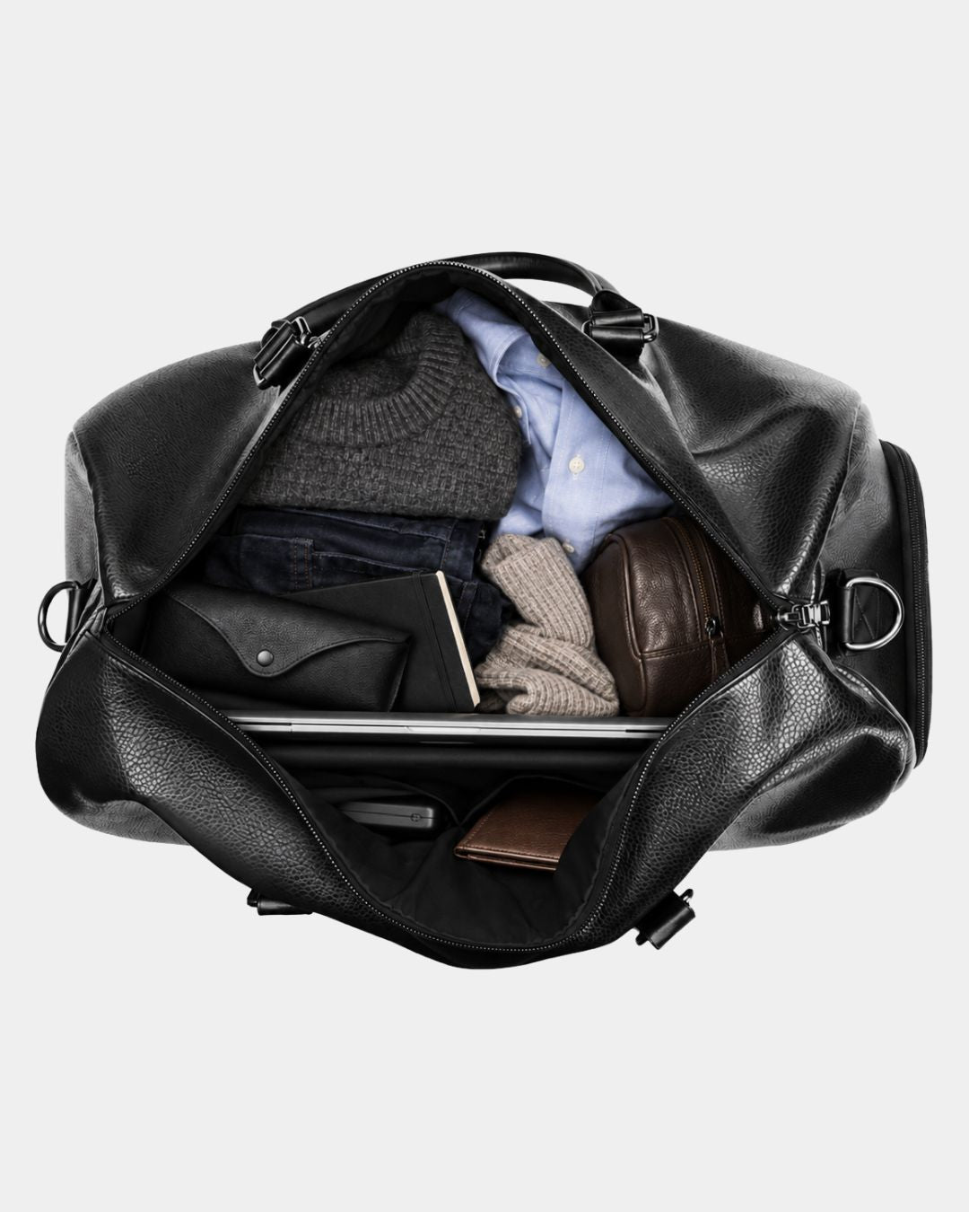 Black textured leather weekender duffel bag filled with folded clothes, a laptop, and travel accessories.
