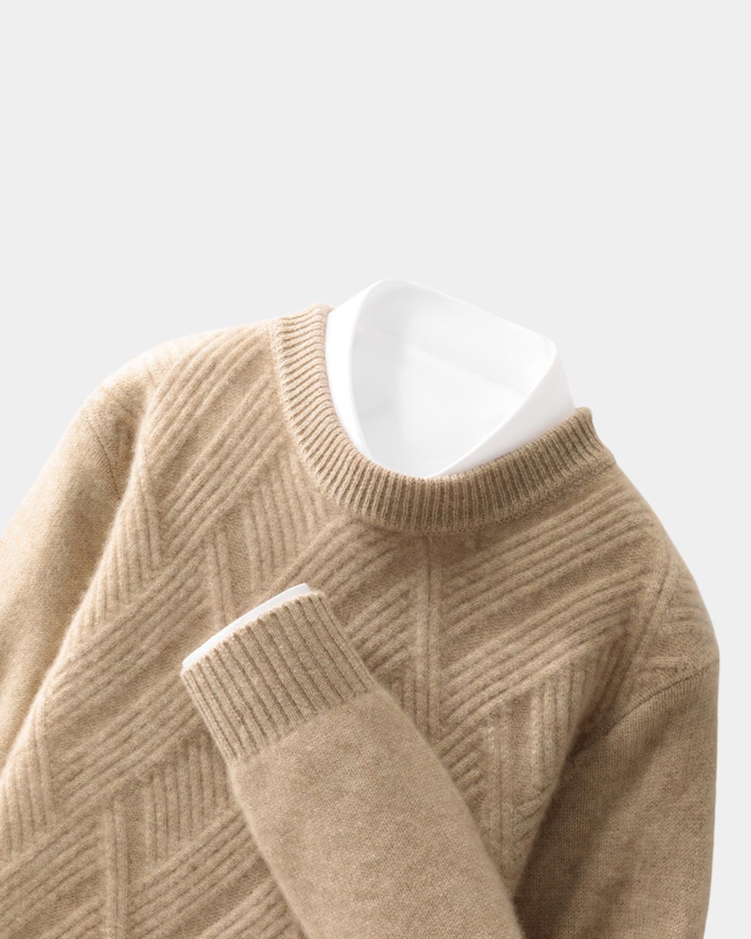 Tan wool crewneck sweater with a raised diamond knit pattern, ribbed trim, and a white collared shirt layered underneath.