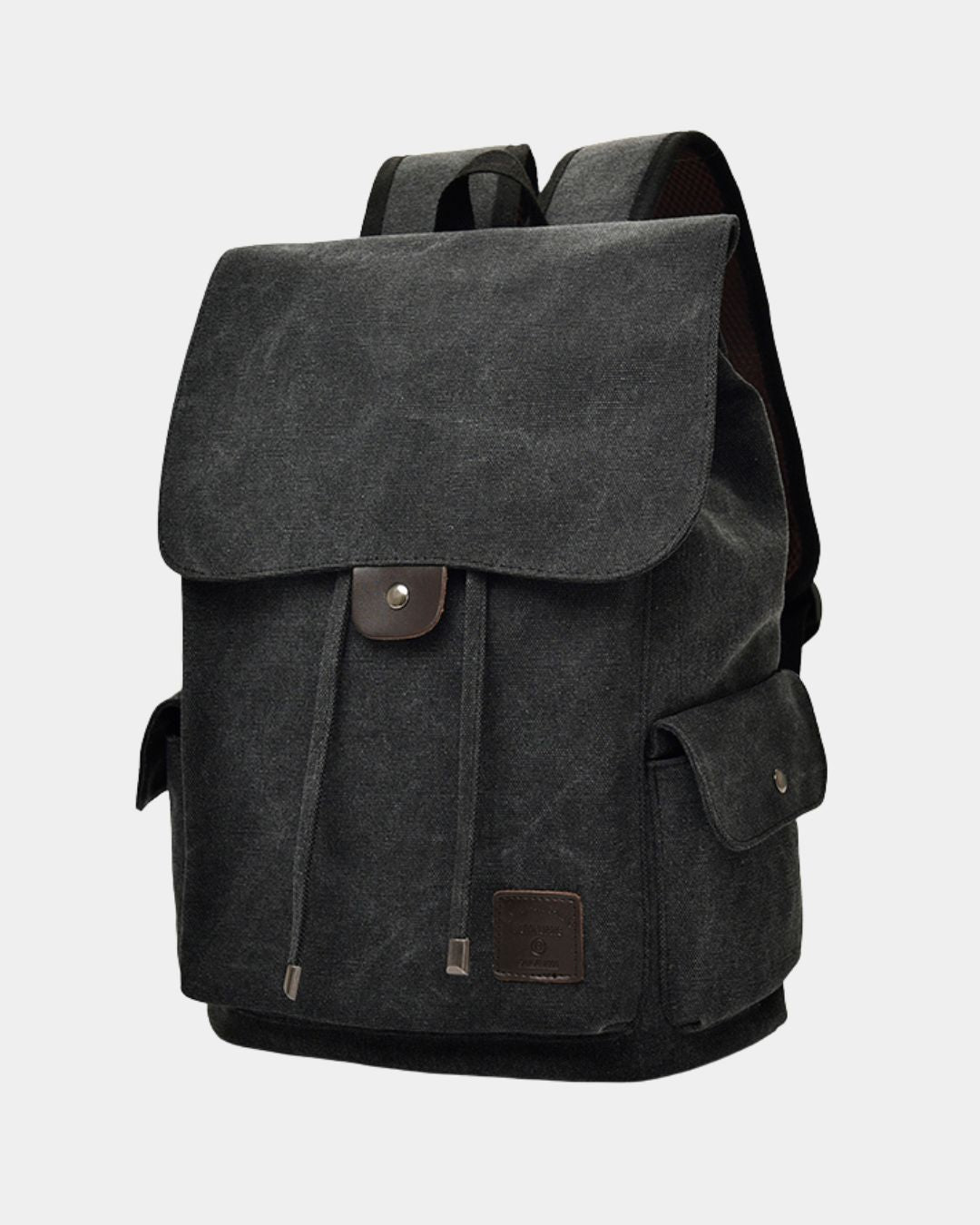 A black canvas backpack with brown leather accents, featuring a front flap pocket with a snap button closure and a side pocket, by Hudson & Tate.
