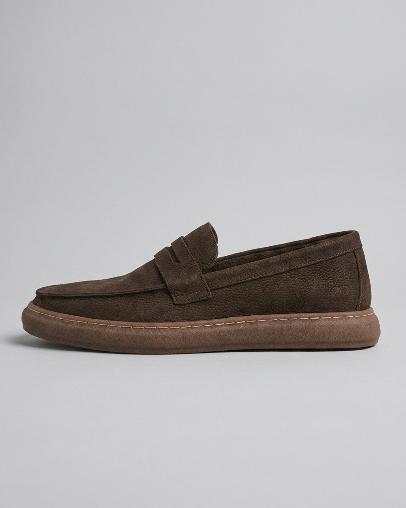 Side view of Salcombe men's dark brown leather penny loafer with moccasin stitching