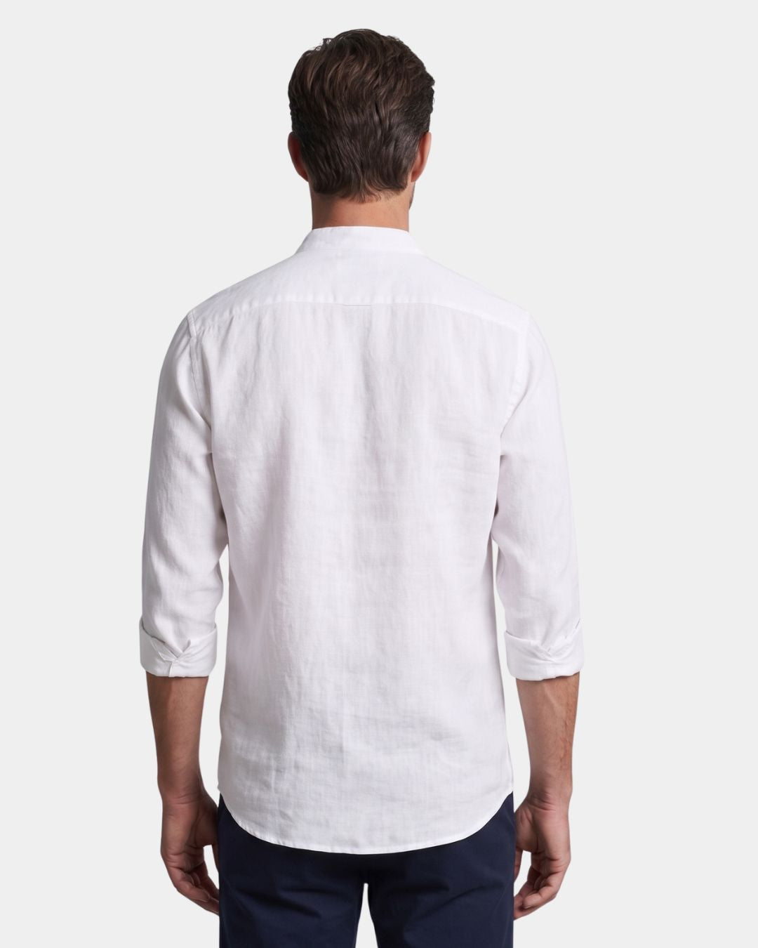 Back view of a white linen-cotton blend men's shirt with a stand collar and long sleeves.