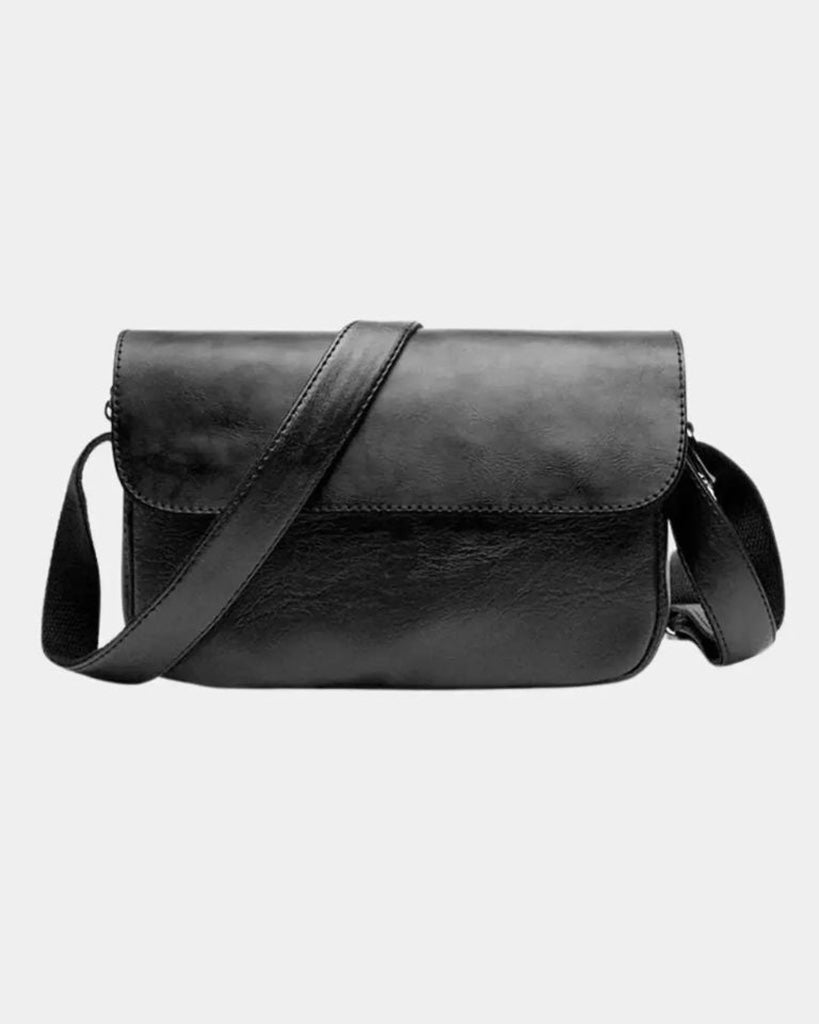 Front view of Torino men's black crossbody bag with structured flap and adjustable shoulder strap