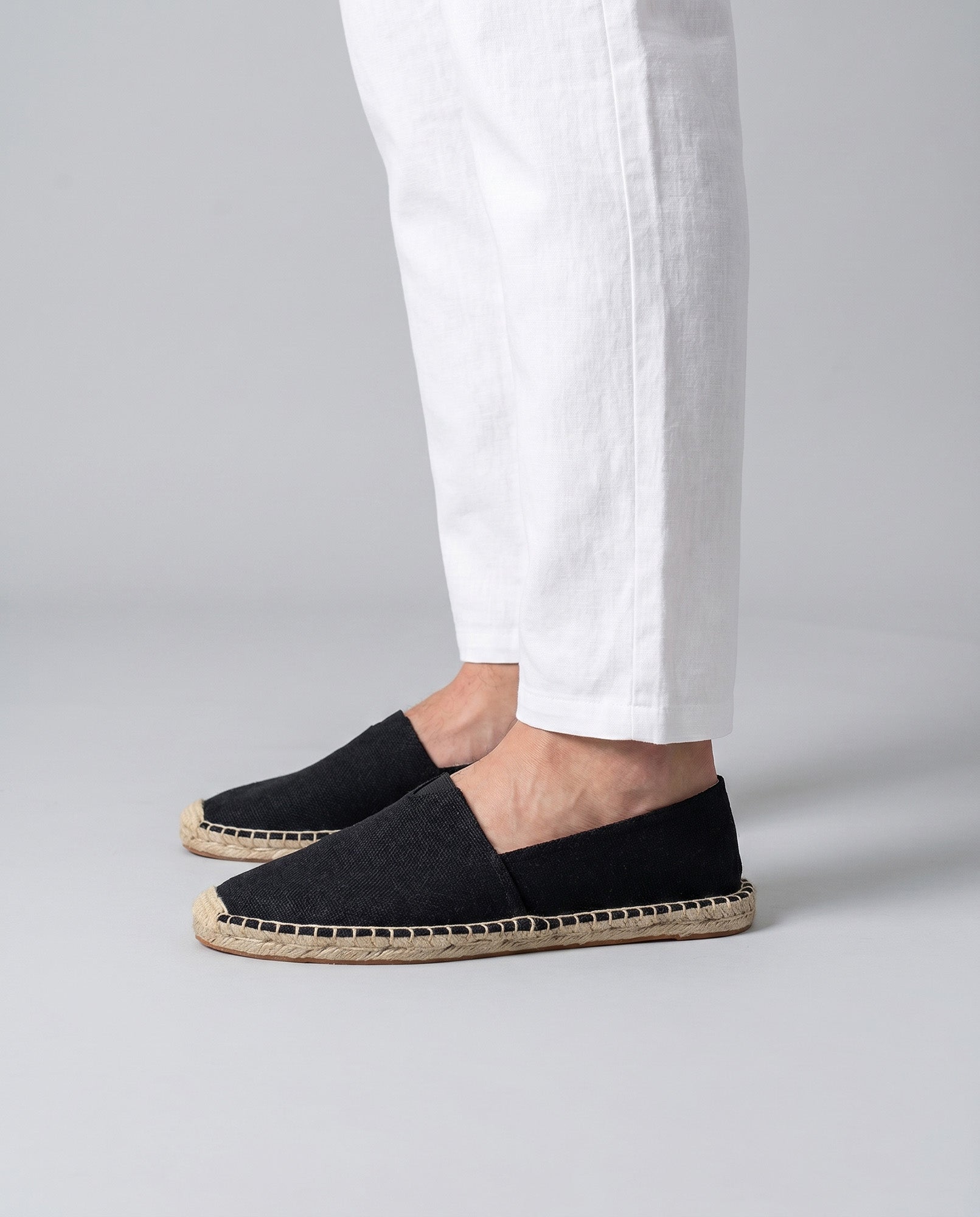 Tulum men's black canvas espadrille loafers worn with white trousers