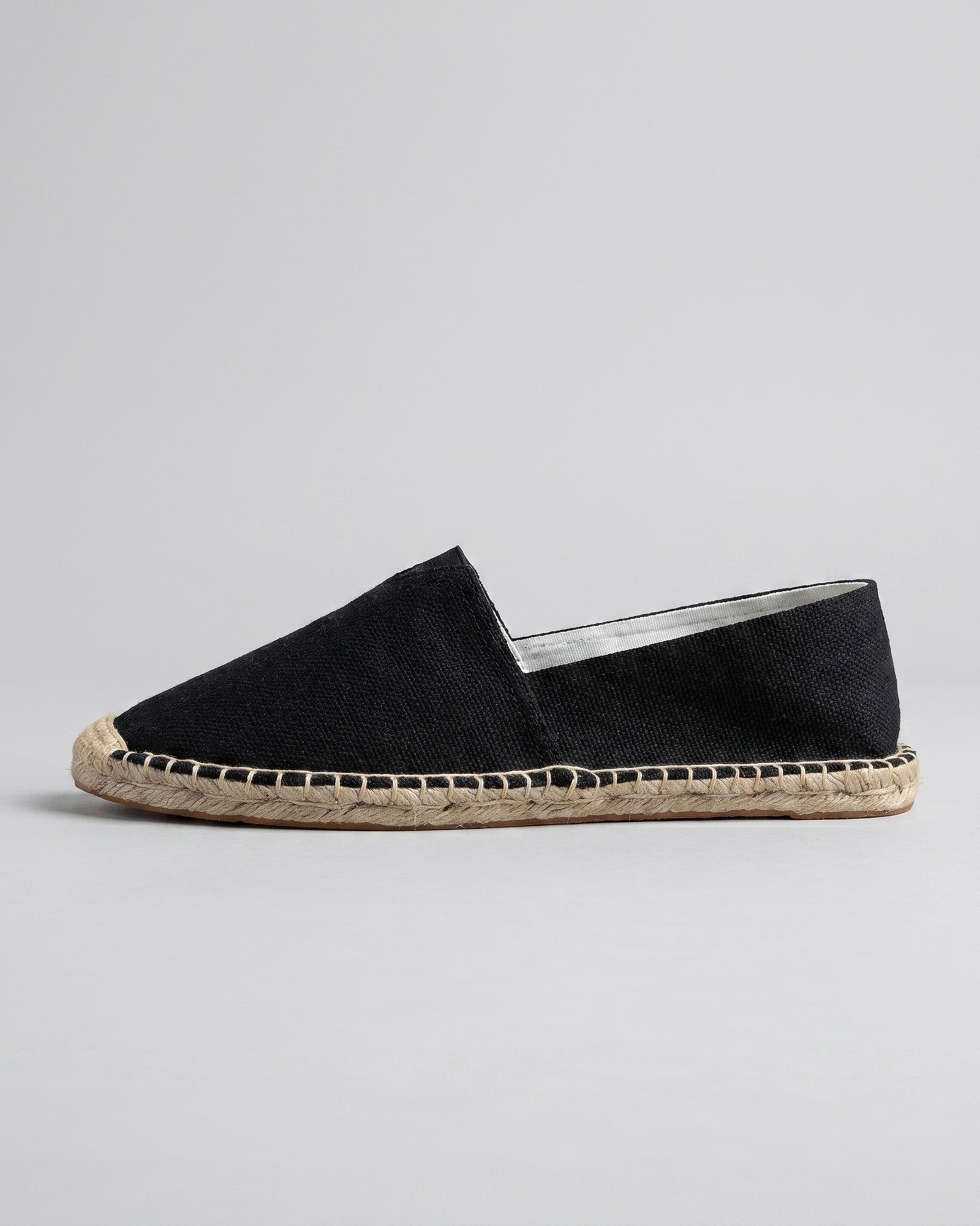 Side view of Tulum men's black canvas espadrille loafer with woven jute sole