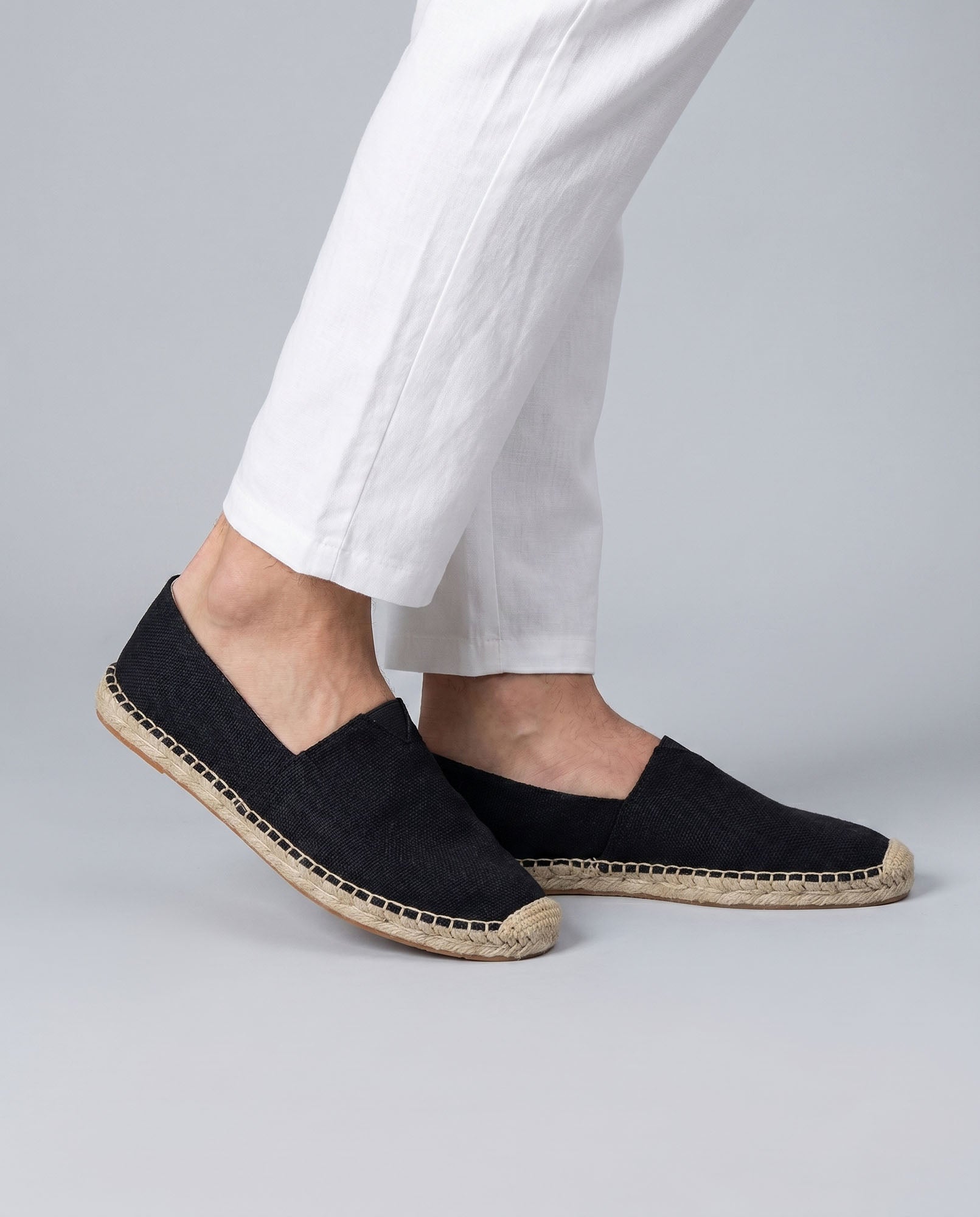 Tulum men's black canvas espadrille loafers styled with white trousers