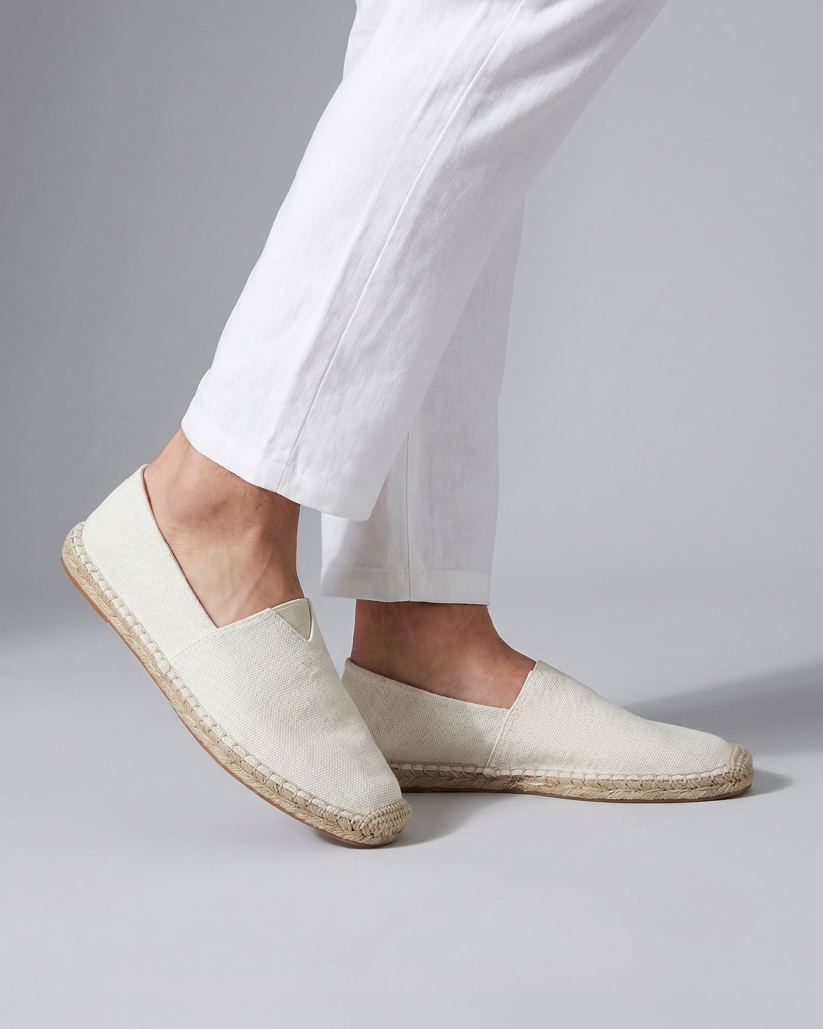 Tulum men's white canvas espadrille loafers worn with white trousers