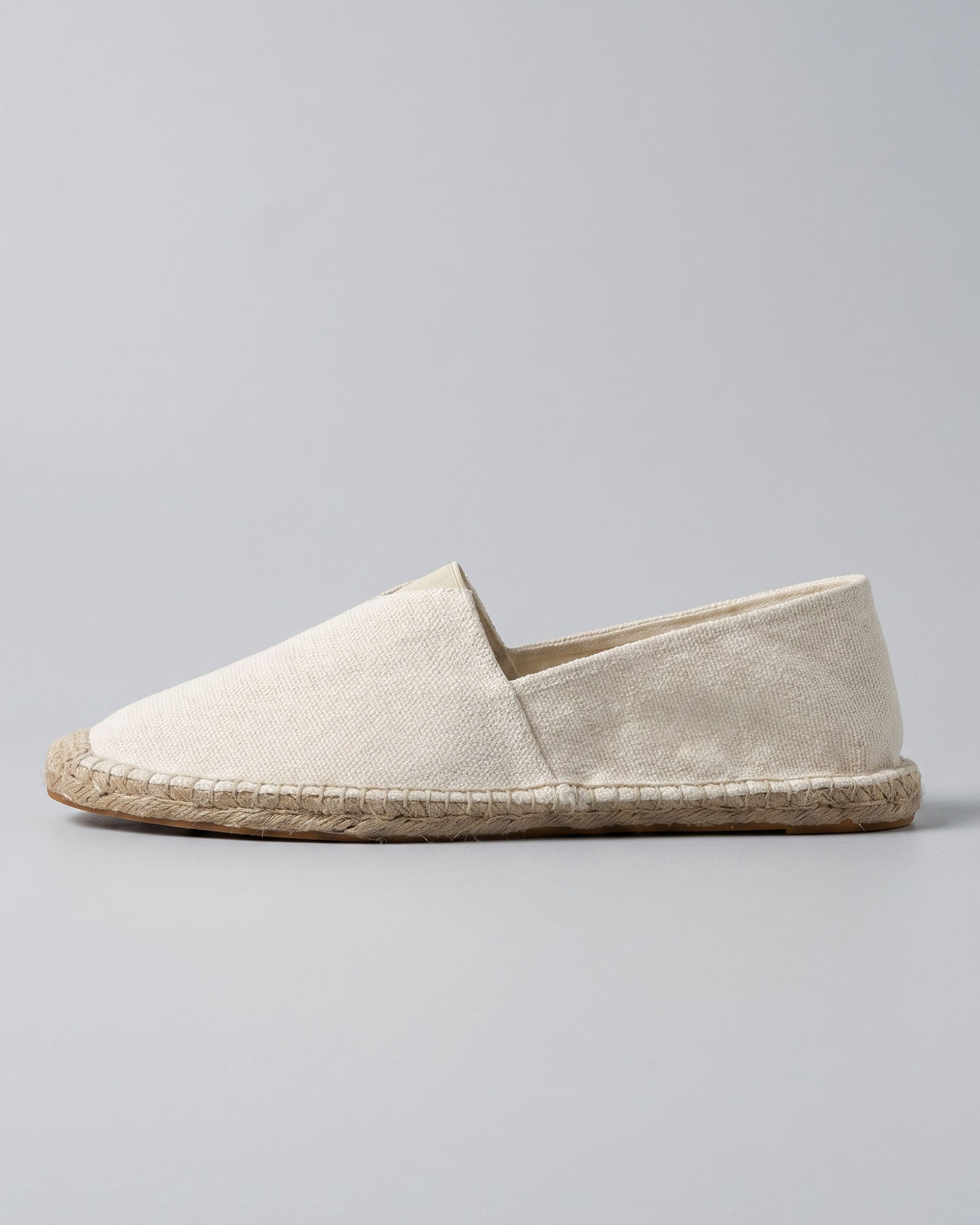 Side view of Tulum men's white canvas espadrille loafer with woven jute sole