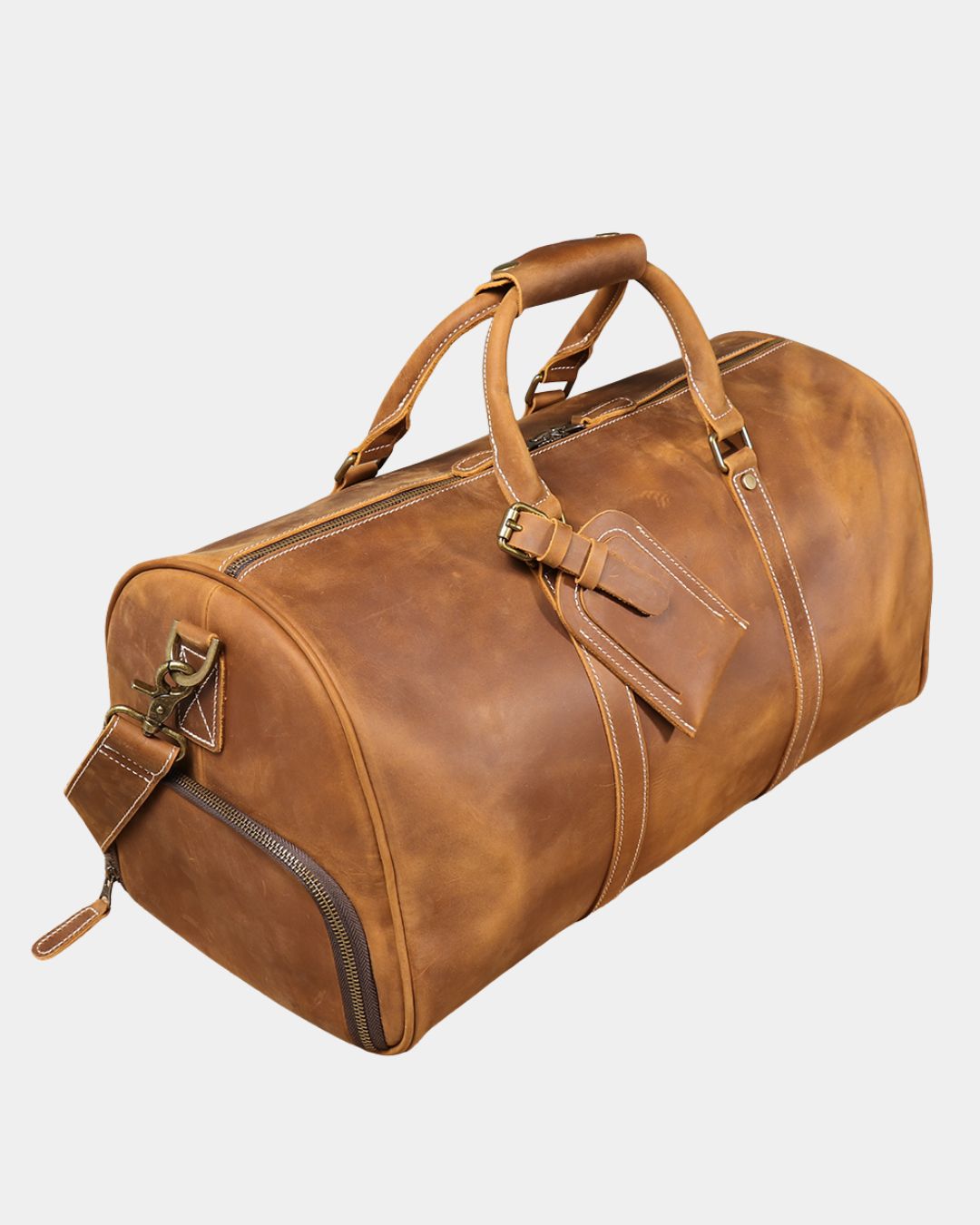 Angled view Men's brown crazy horse leather duffel bag with luggage tag and crossbody strap by Hudson & Tate.