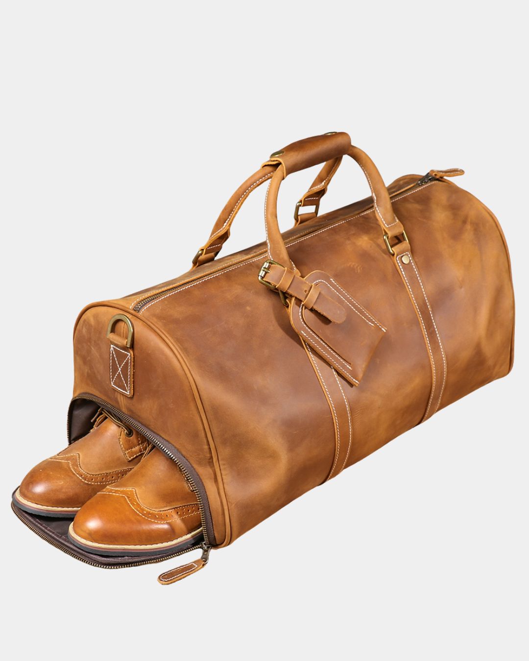Interior view of shoe compartment of Men's brown crazy horse leather duffel bag with luggage tag and crossbody strap by Hudson & Tate.