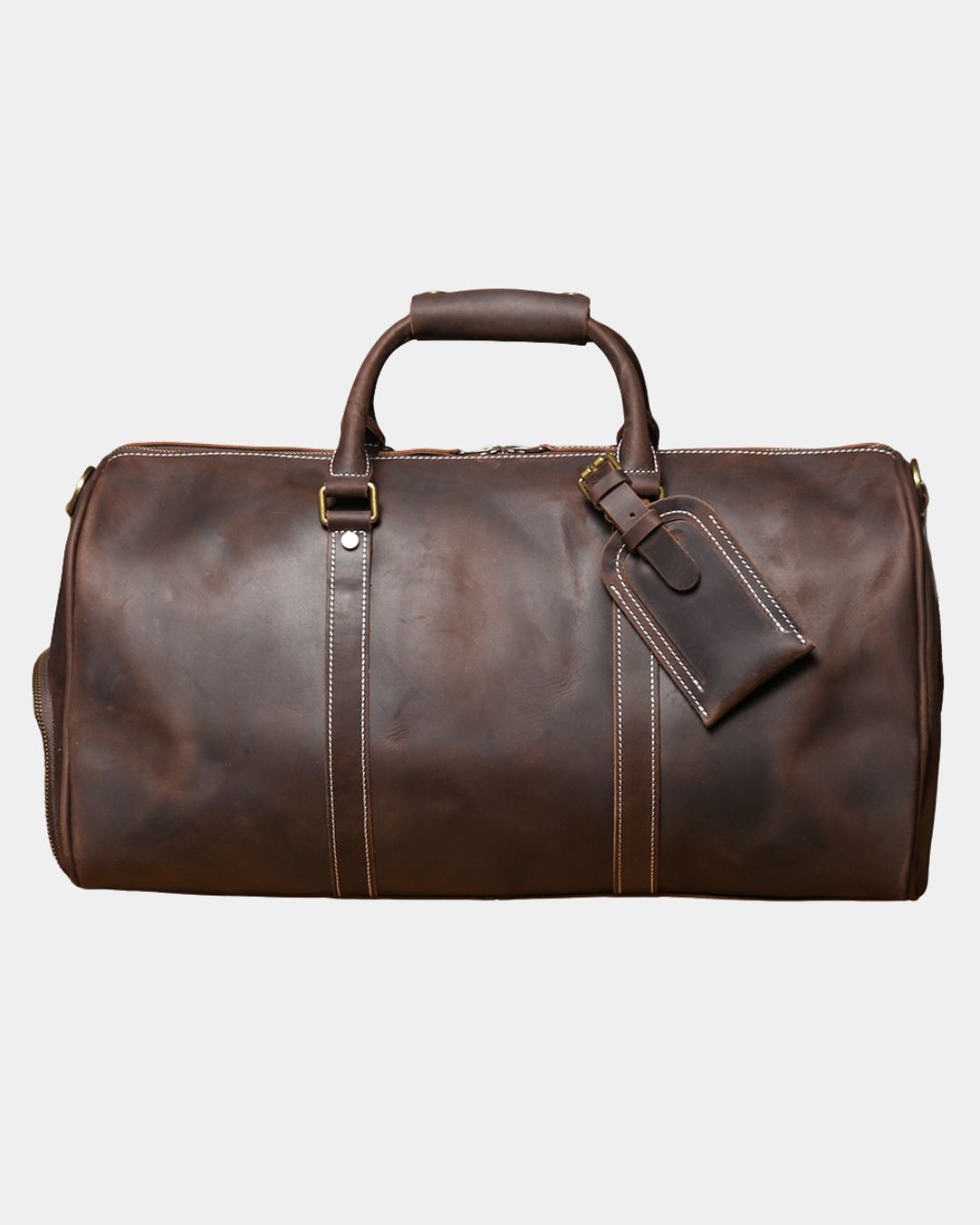 Front view of Men's dark brown crazy horse leather duffel bag with luggage tag and crossbody strap by Hudson & Tate.