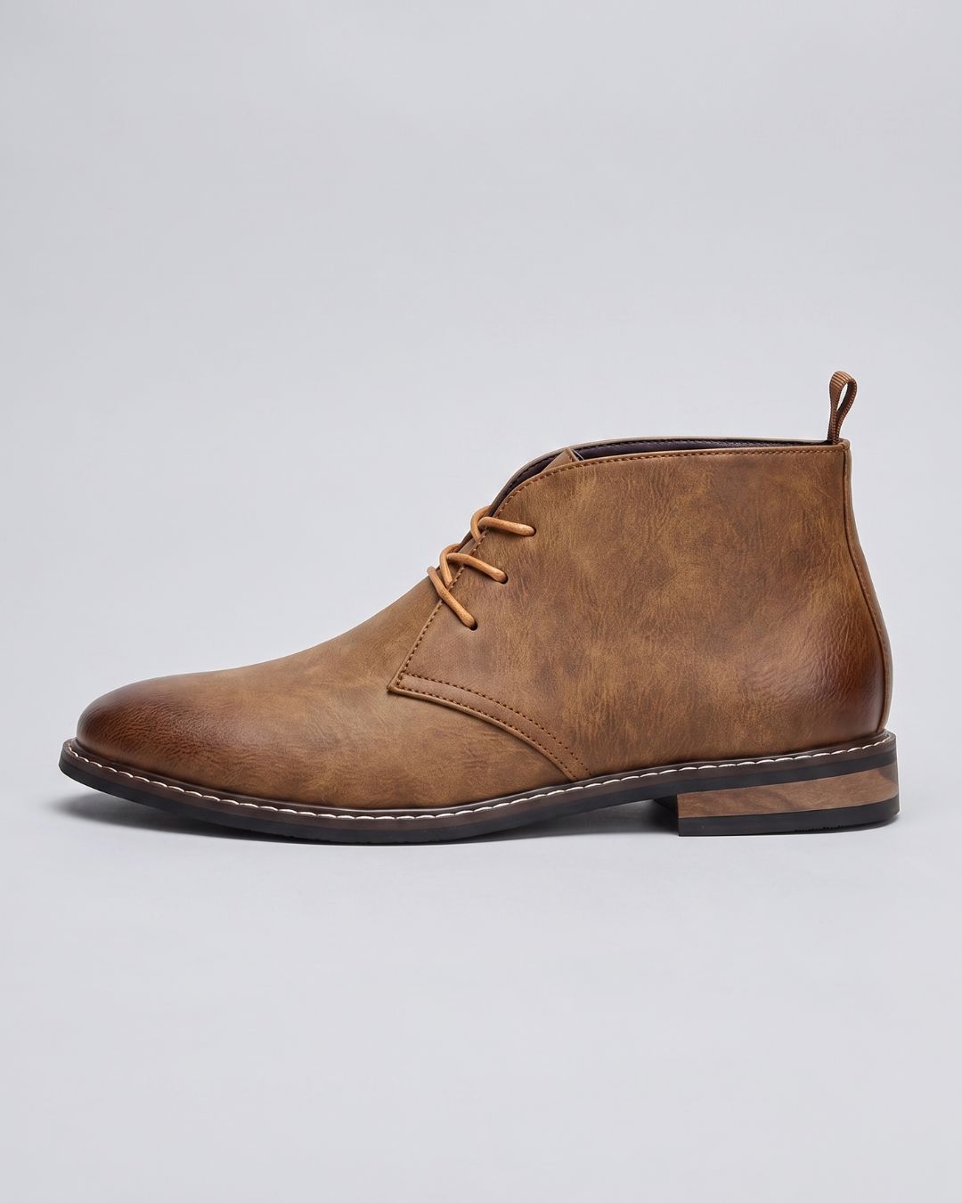 A single tan leather chukka boot with a distressed finish, tan laces, and a low stacked heel, by Hudson & Tate.
