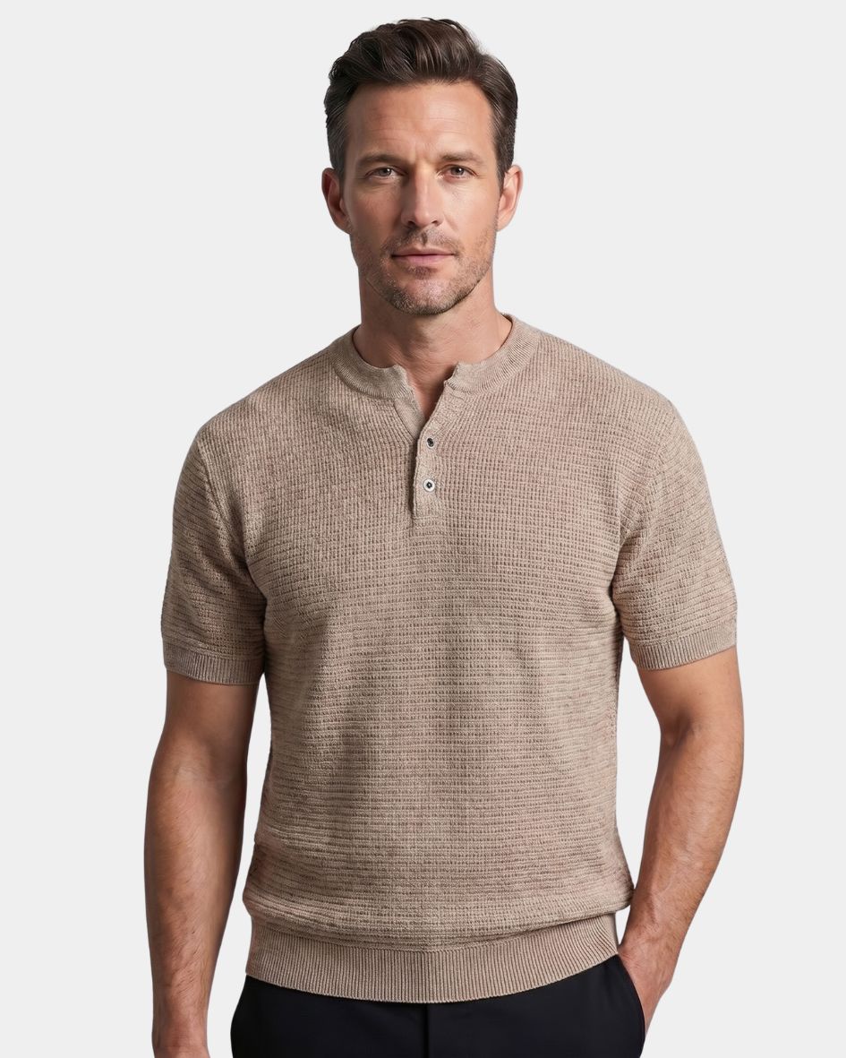 Man wearing a beige short-sleeve henley shirt against a light gray background