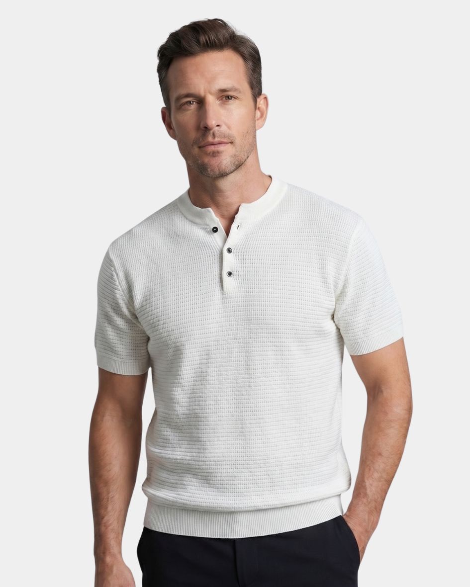 Man wearing a light gray short-sleeve henley shirt on a white background