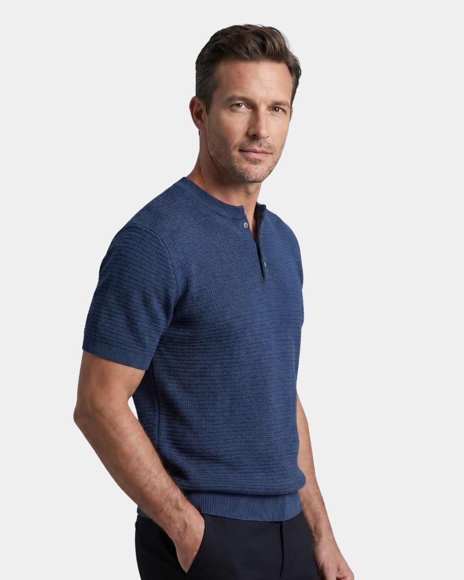Man wearing a blue short-sleeve shirt on a light gray background