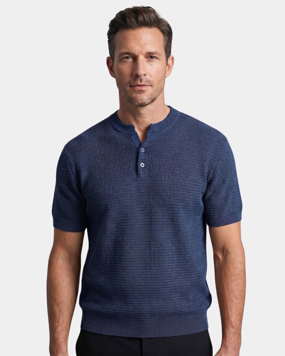 Man wearing a blue short-sleeve henley shirt on a light gray background