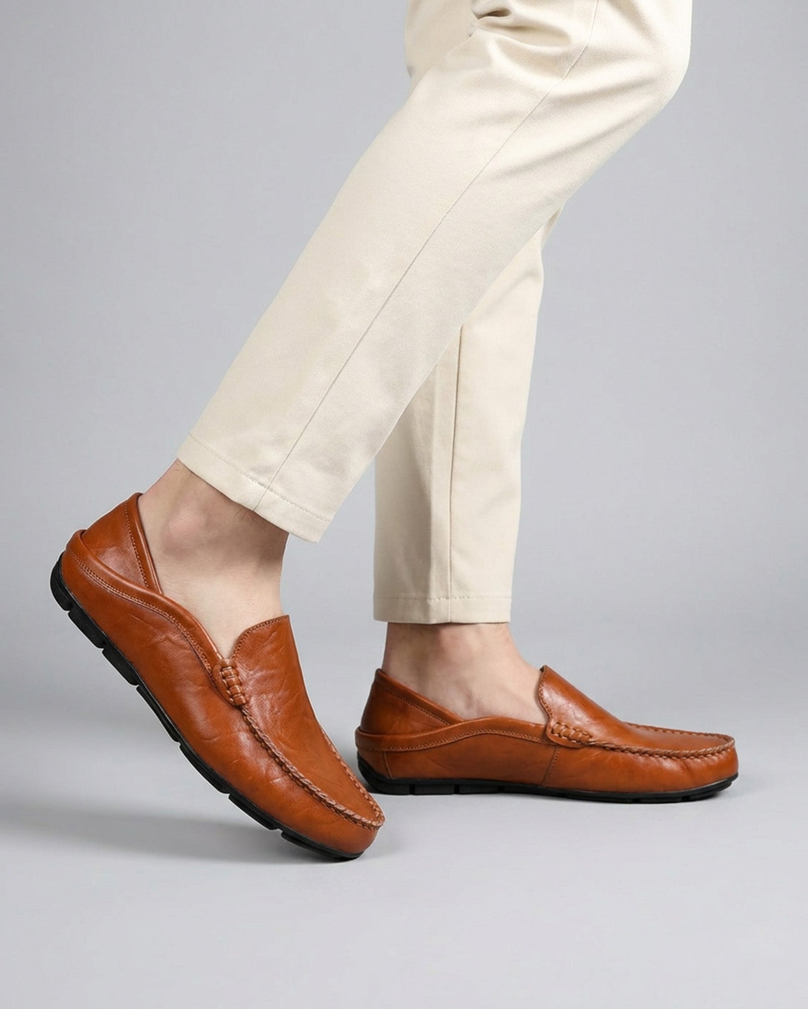 Beckett men's cognac leather driving loafers styled while walking