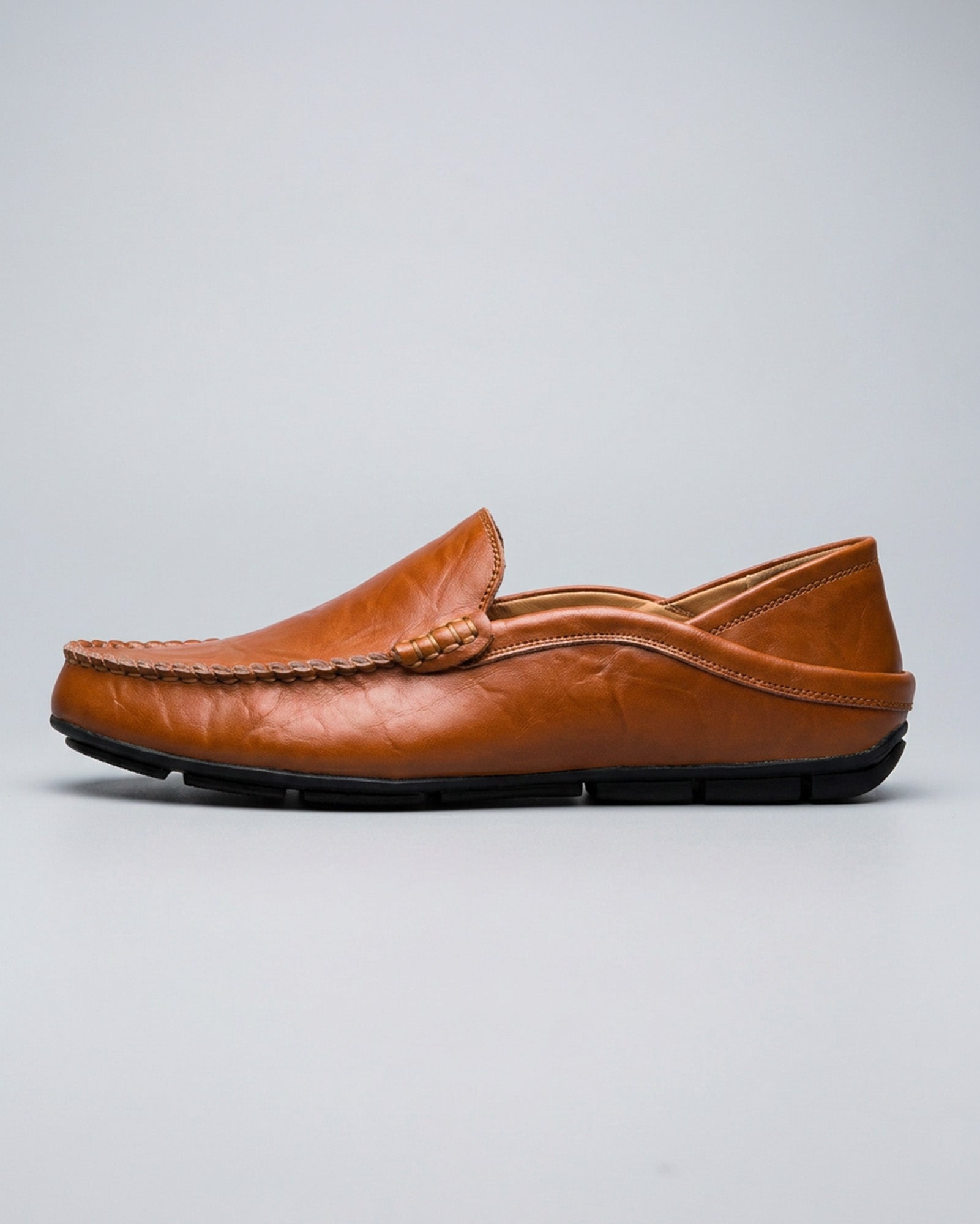 Side view of Beckett men's cognac leather driving loafer