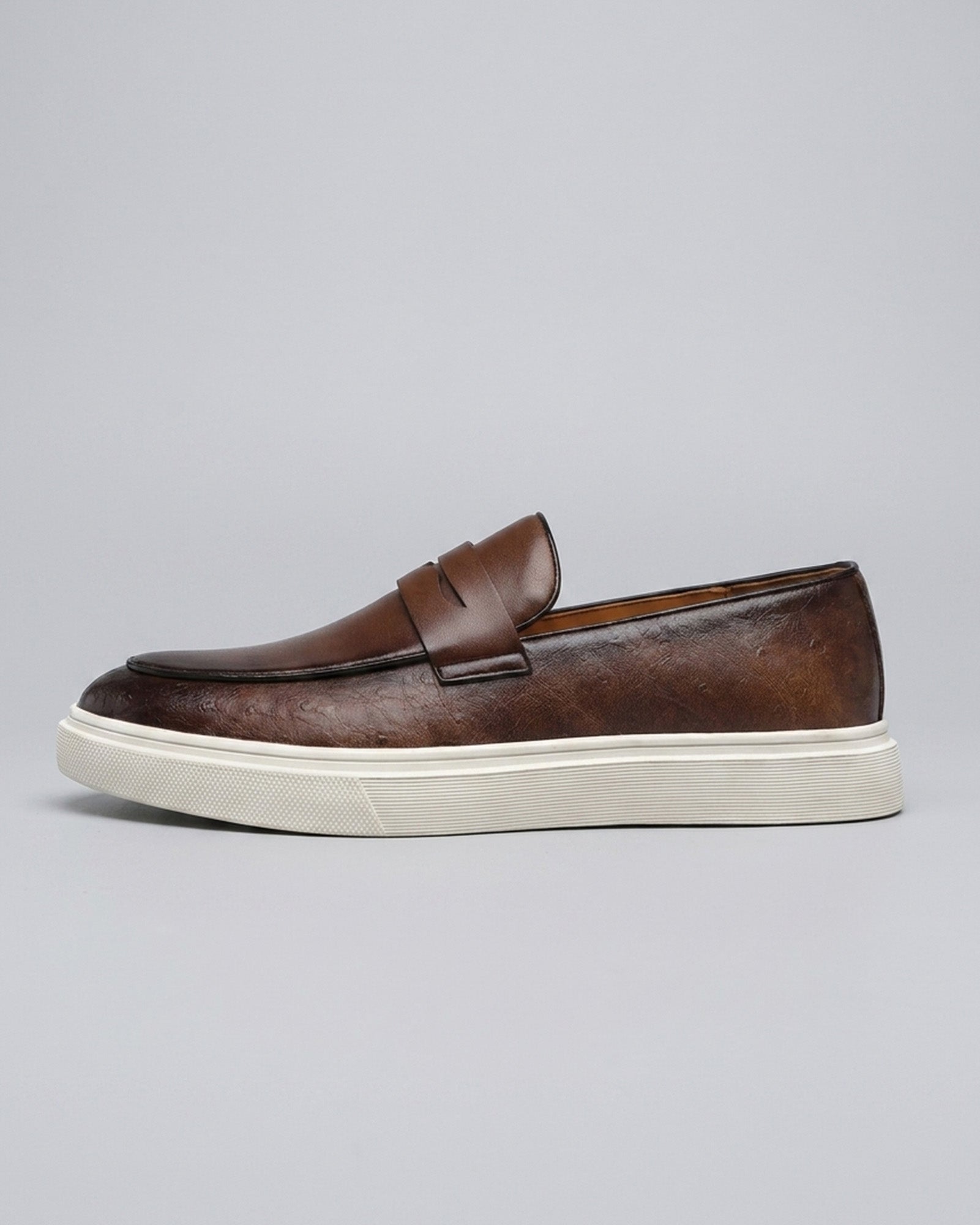 Side view of Belmont men's brown penny loafer sneaker with off-white cupsole