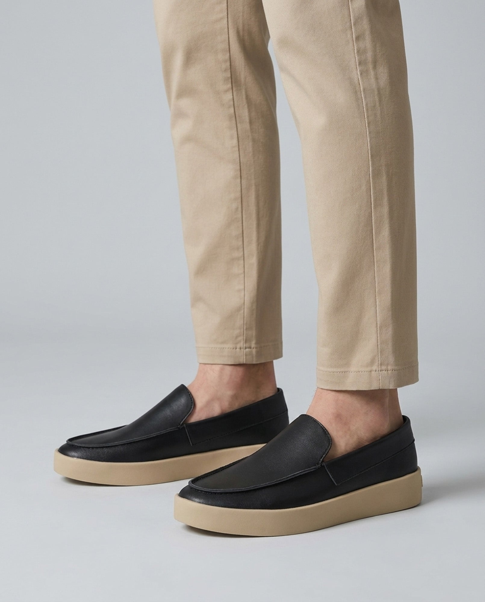 Side profile of Boston men's black slip-on loafers with chunky cream cupsole