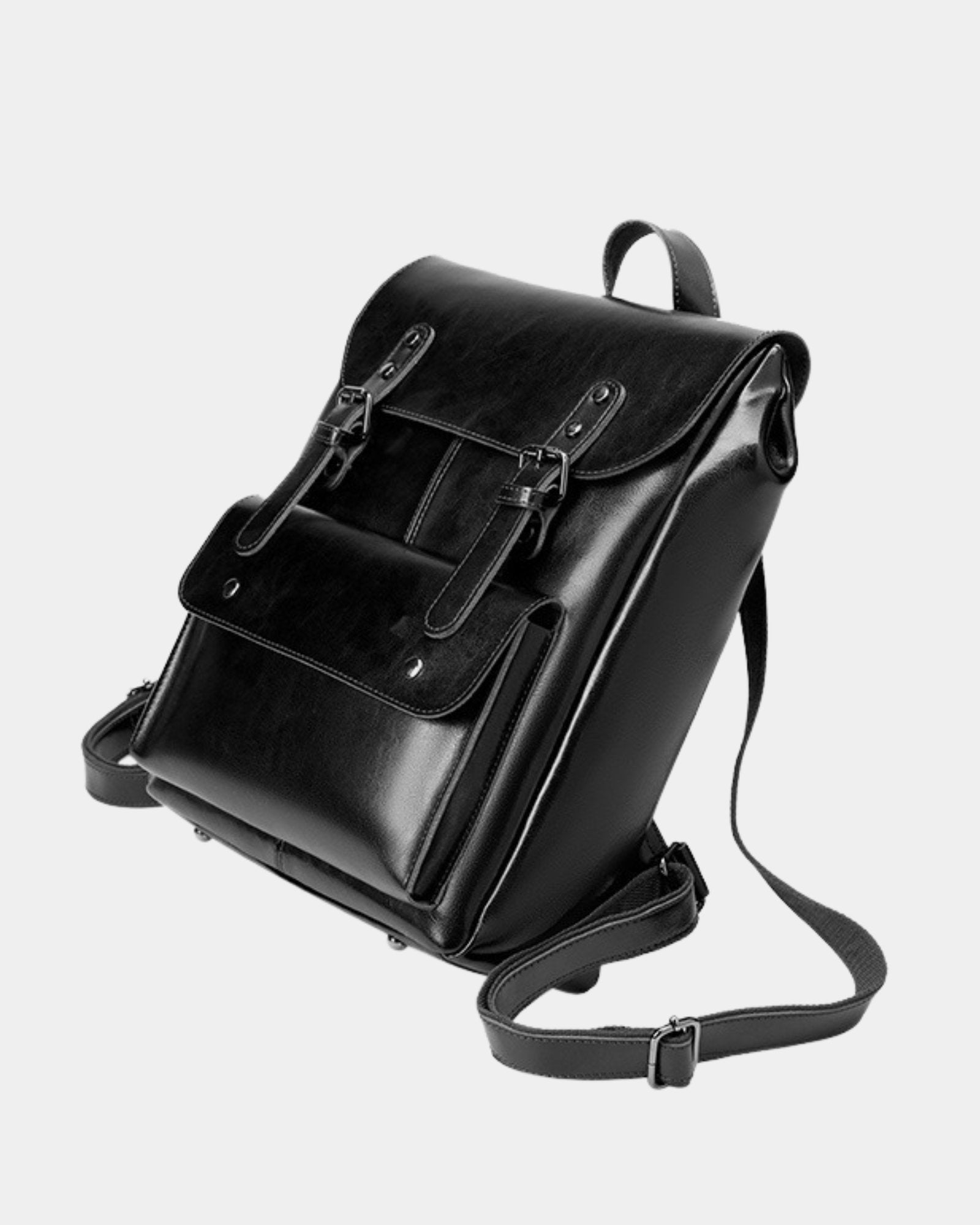 Three-quarter view of Cambridge black leather backpack showing structured flap and adjustable straps