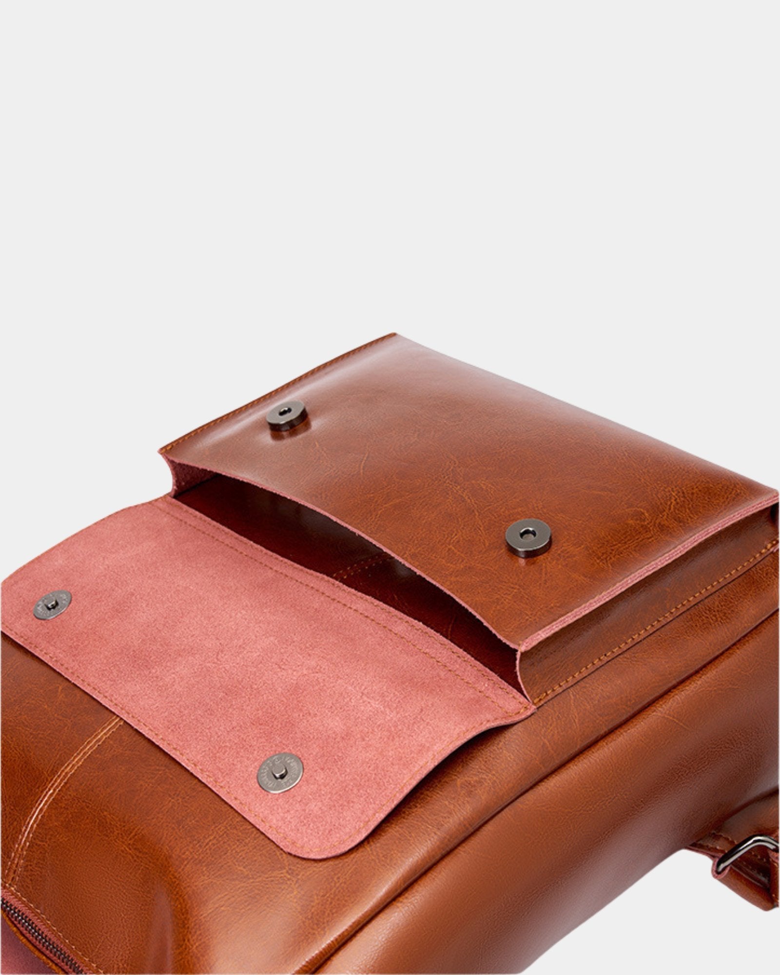 Close-up of Cambridge brown leather backpack showing open pocket flap and magnetic snap detail