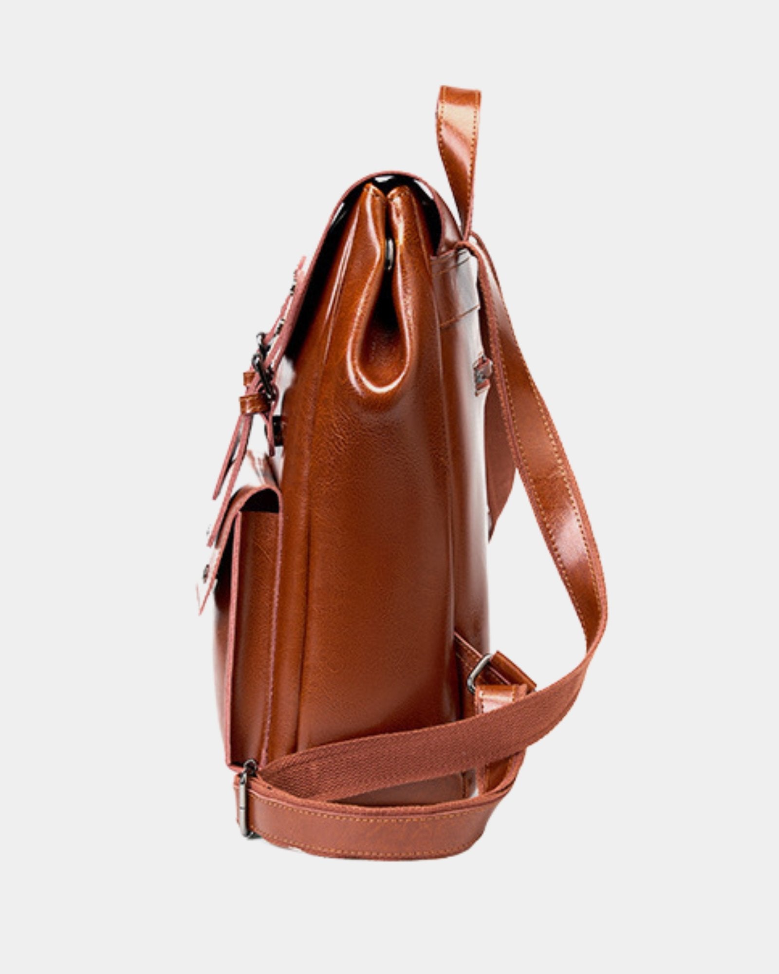 Side profile of Cambridge brown leather backpack showing depth and top handle