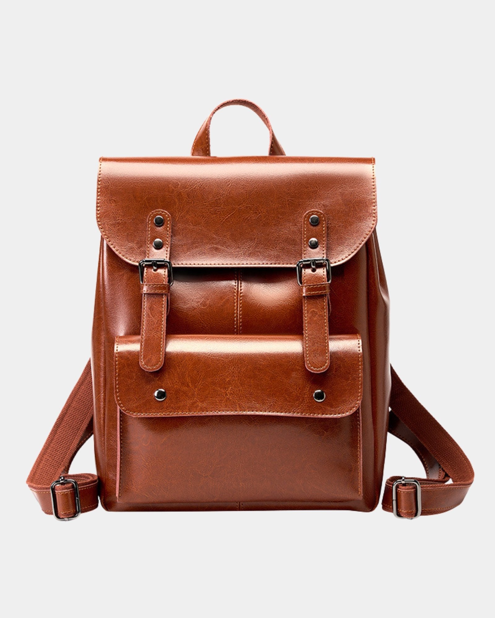 Front view of Cambridge brown leather backpack with dual buckle straps and dark metal hardware