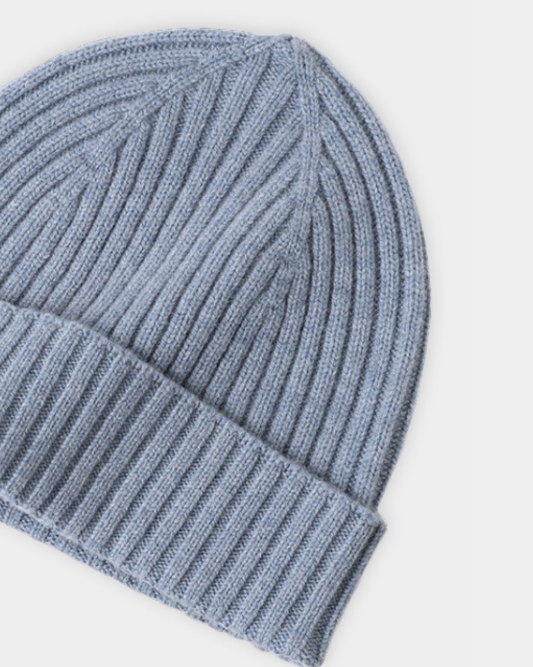 Light blue cashmere beanie with a ribbed knit texture and a folded cuff for a soft, minimalist winter style.